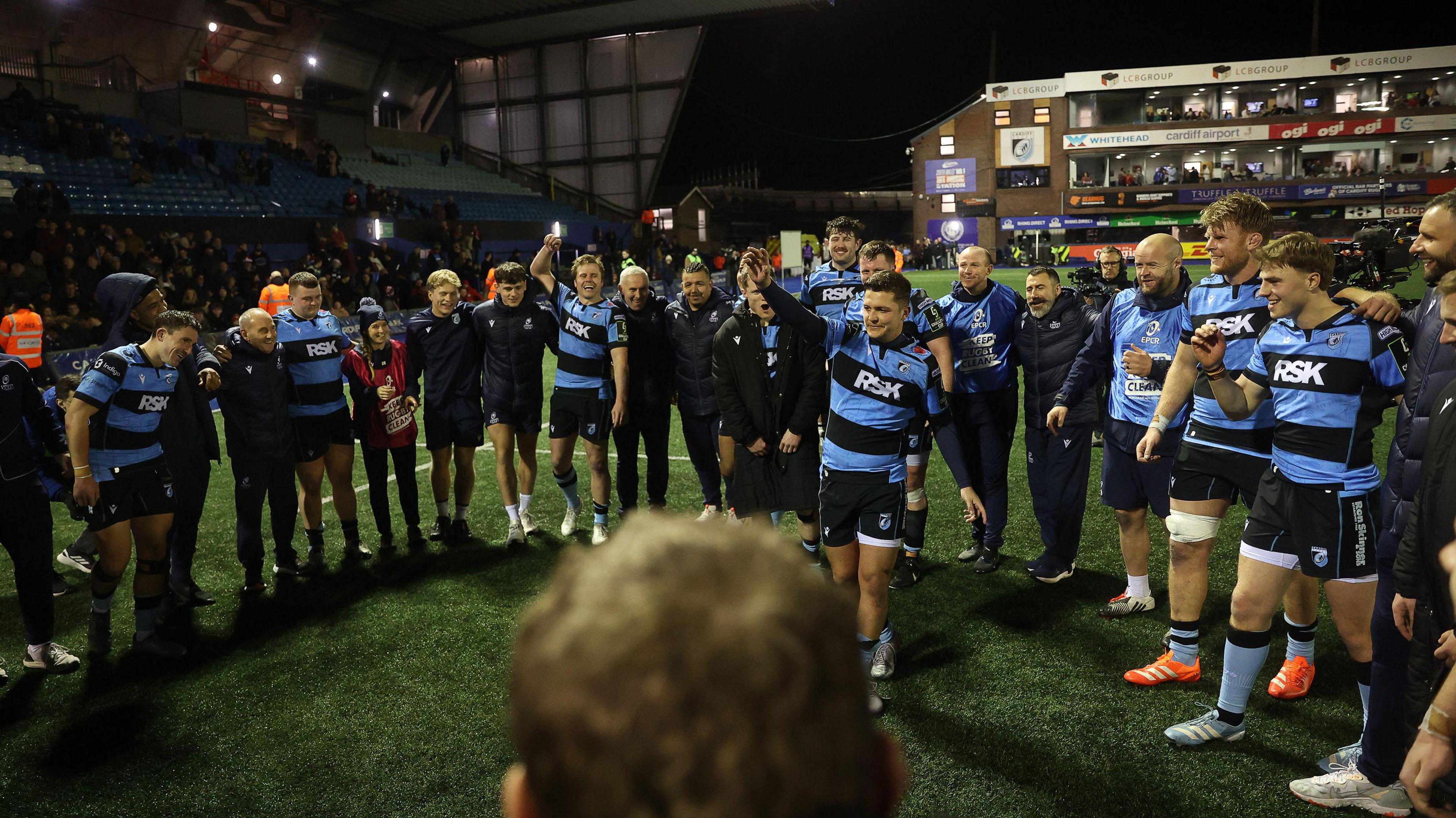 Callum Sheedy leads the celebrations in a ring of Cardiff players on the pitch after the win against Ulster at the Arms Park