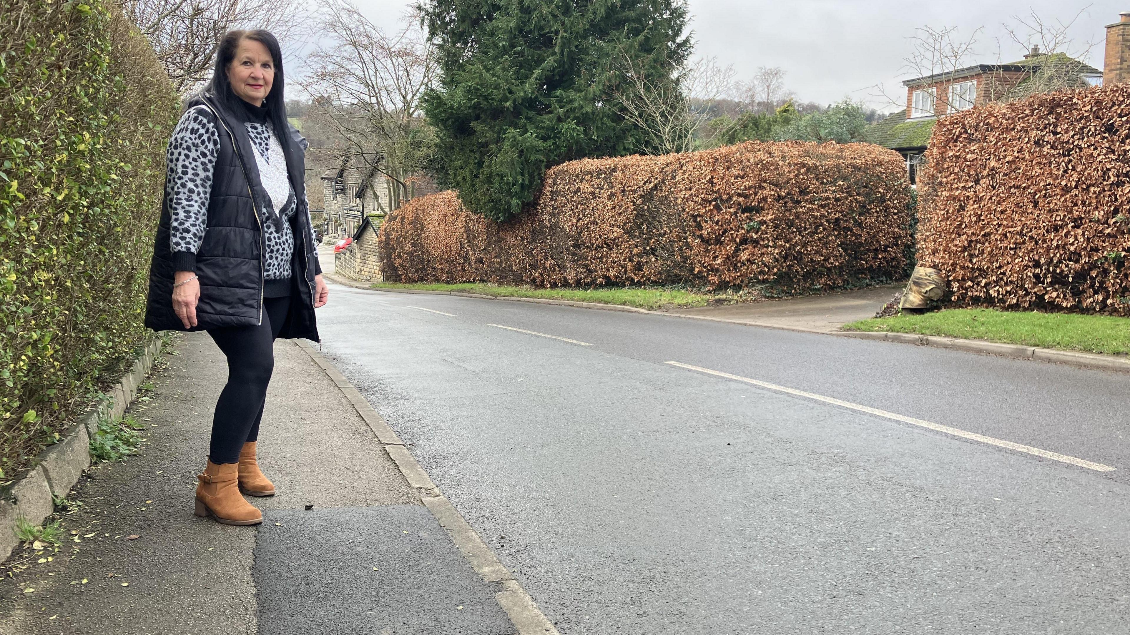 Ann Lilley, from near Harrogate, standing by the section of pavement where she had her accident in 2023.