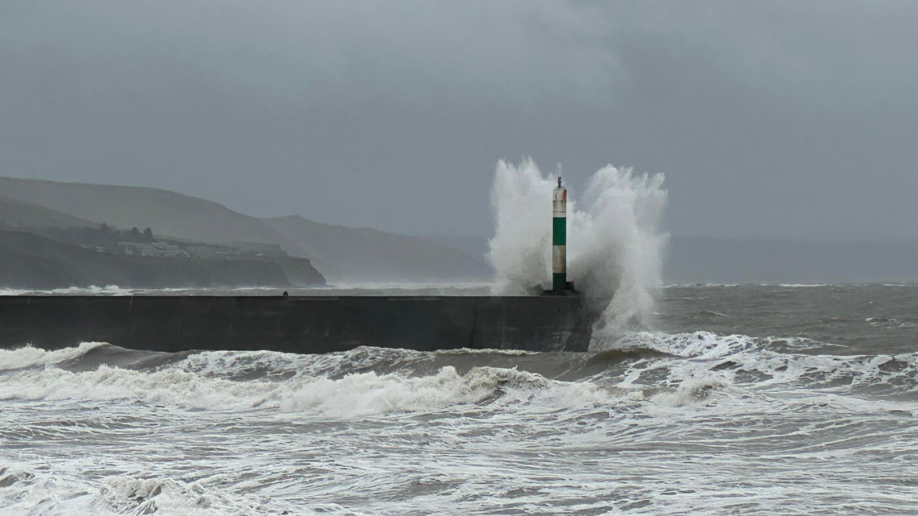 Waves crash on to the breakwater at Aberystwyth