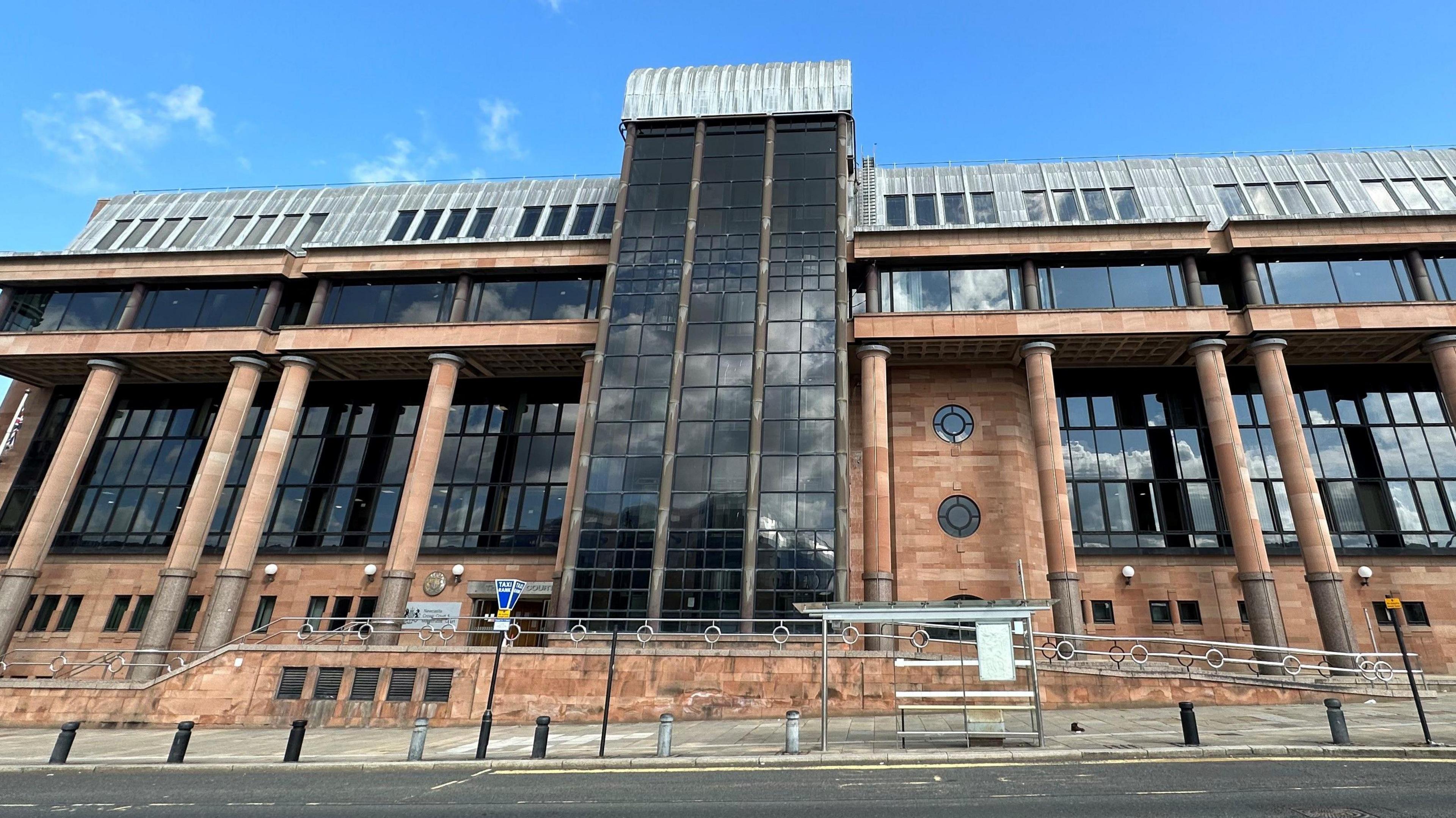 Court building. It is imposing and is made of red bricks, columns and large dark windows