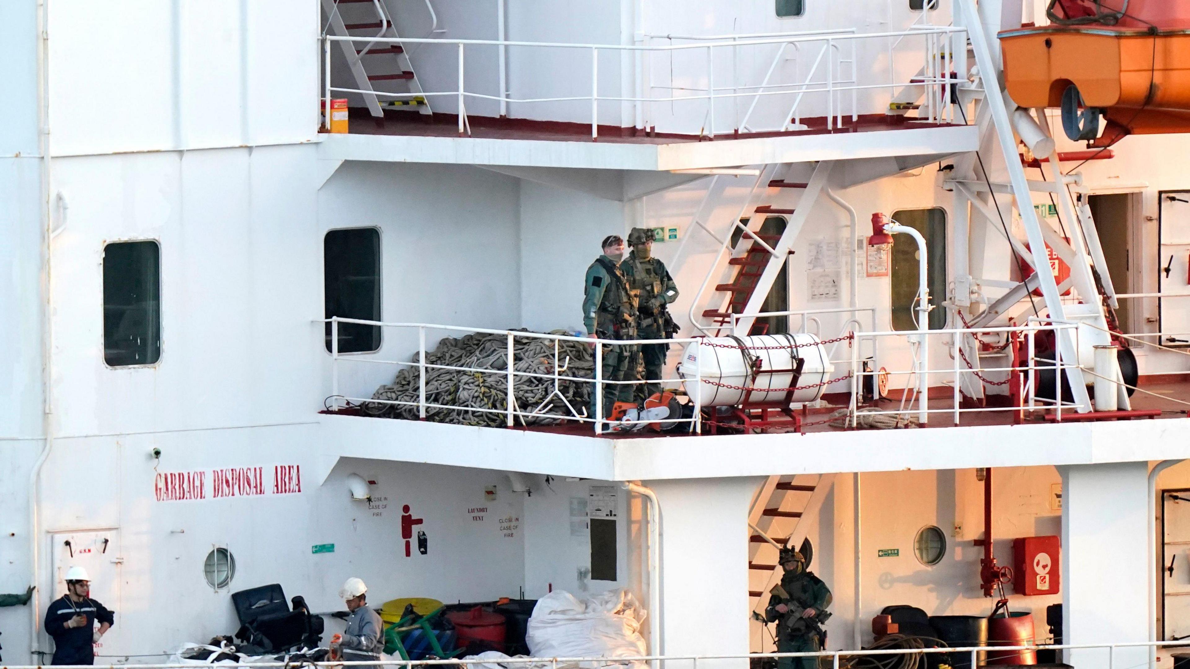 Army Rangers pictured onboard multiple levels of the MV Matthew, large white multi level decking area with ladders connecting them