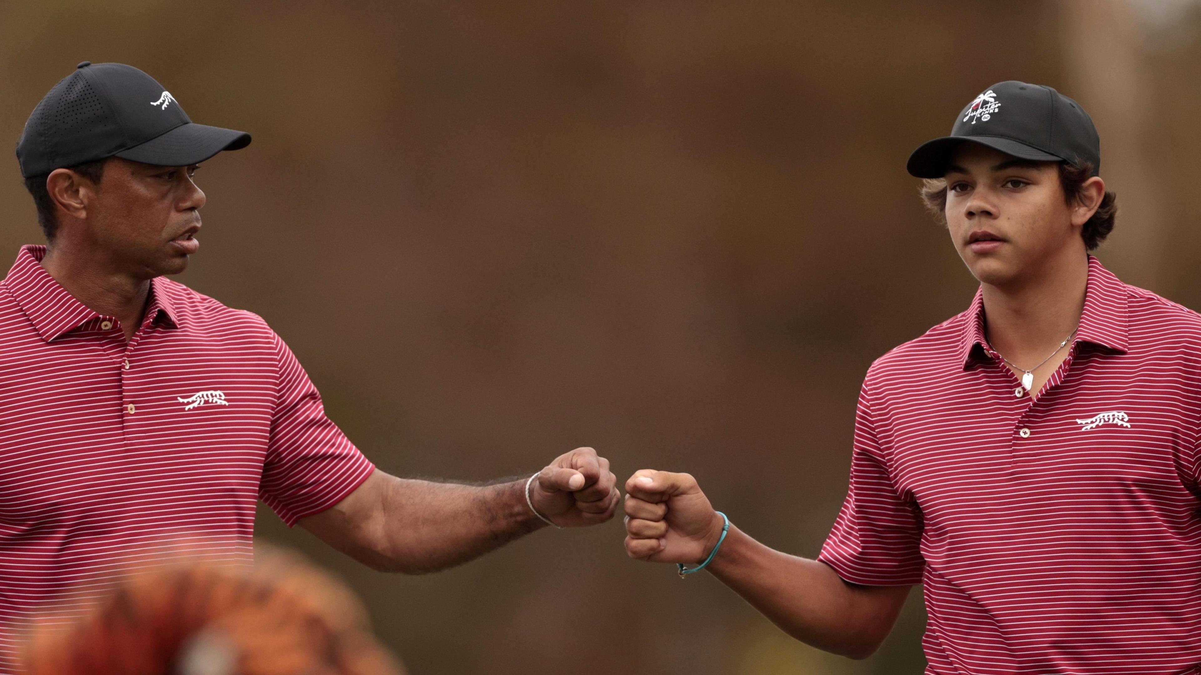 Tiger Woods and Charlie Woods bump fists at the PNC Championship 