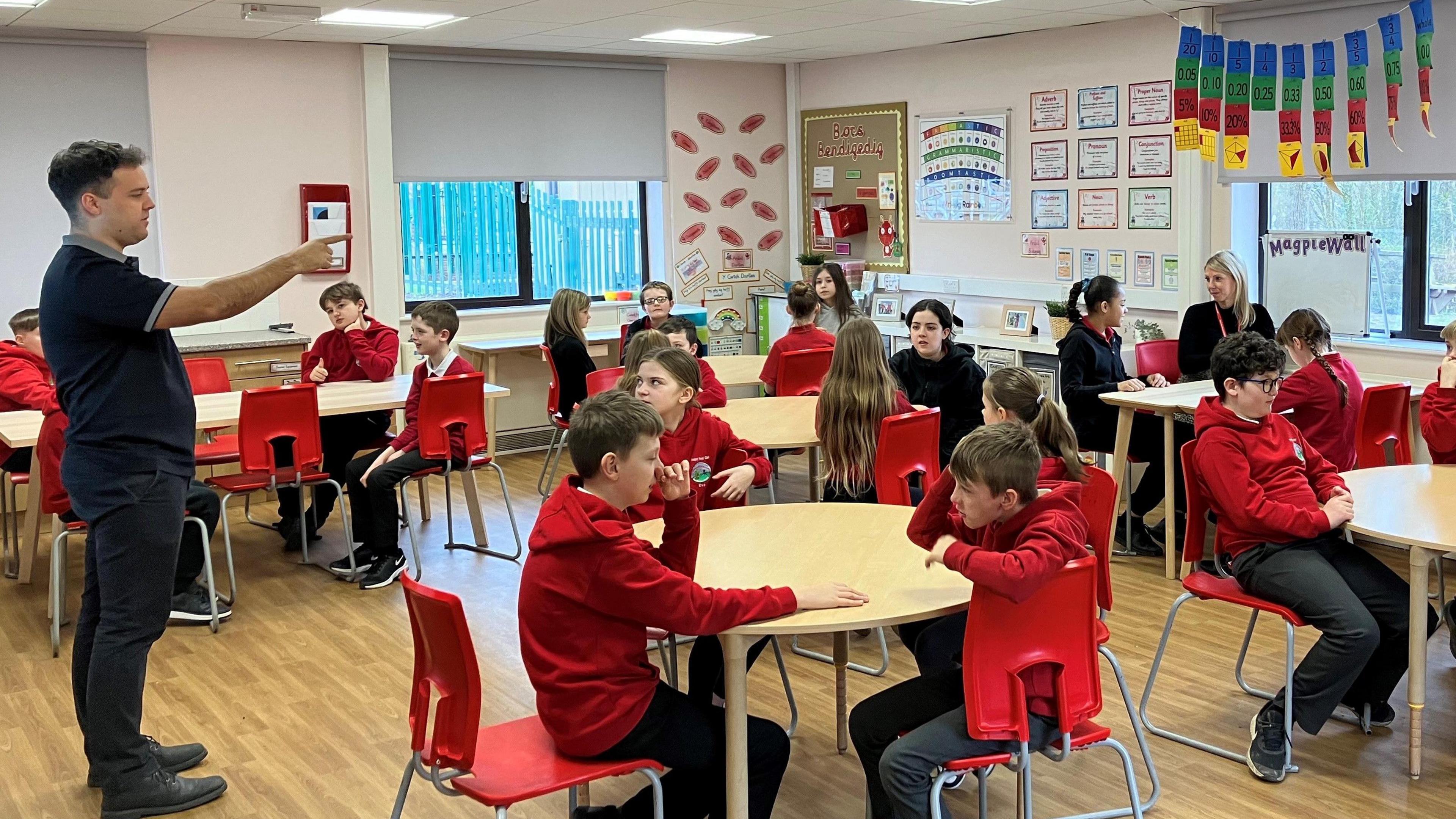 A teacher in front of a classroom at a primary school near Caerphilly