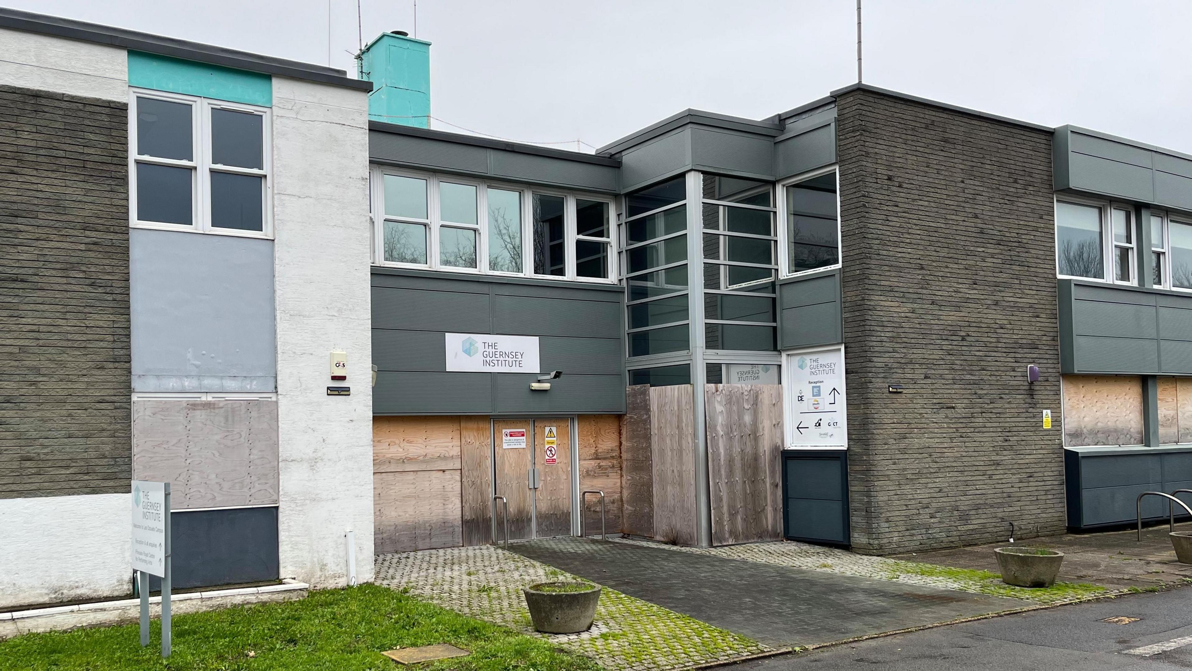 Outside the building of the old St Peter Port school. It's all boarded up 