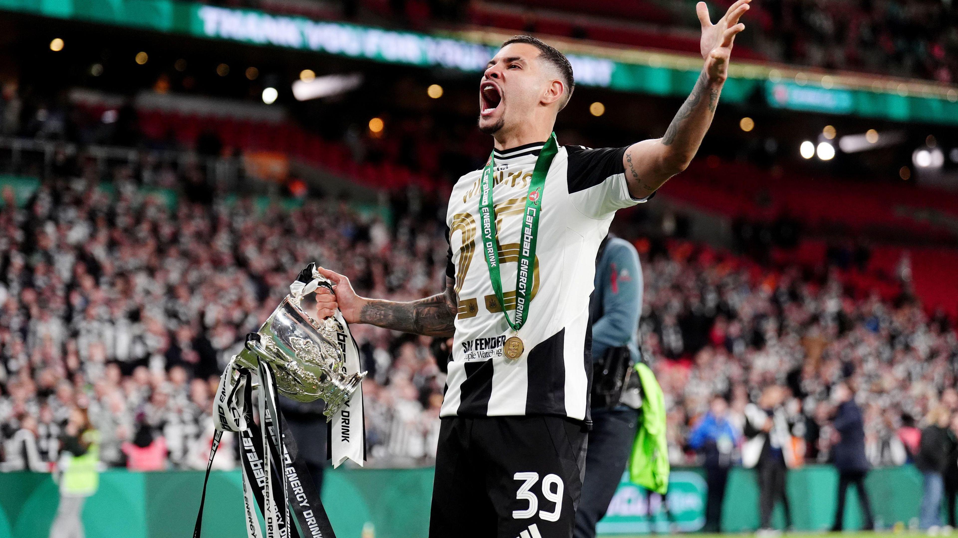 Bruno Guimaraes celebrates holding the Carabao Cup