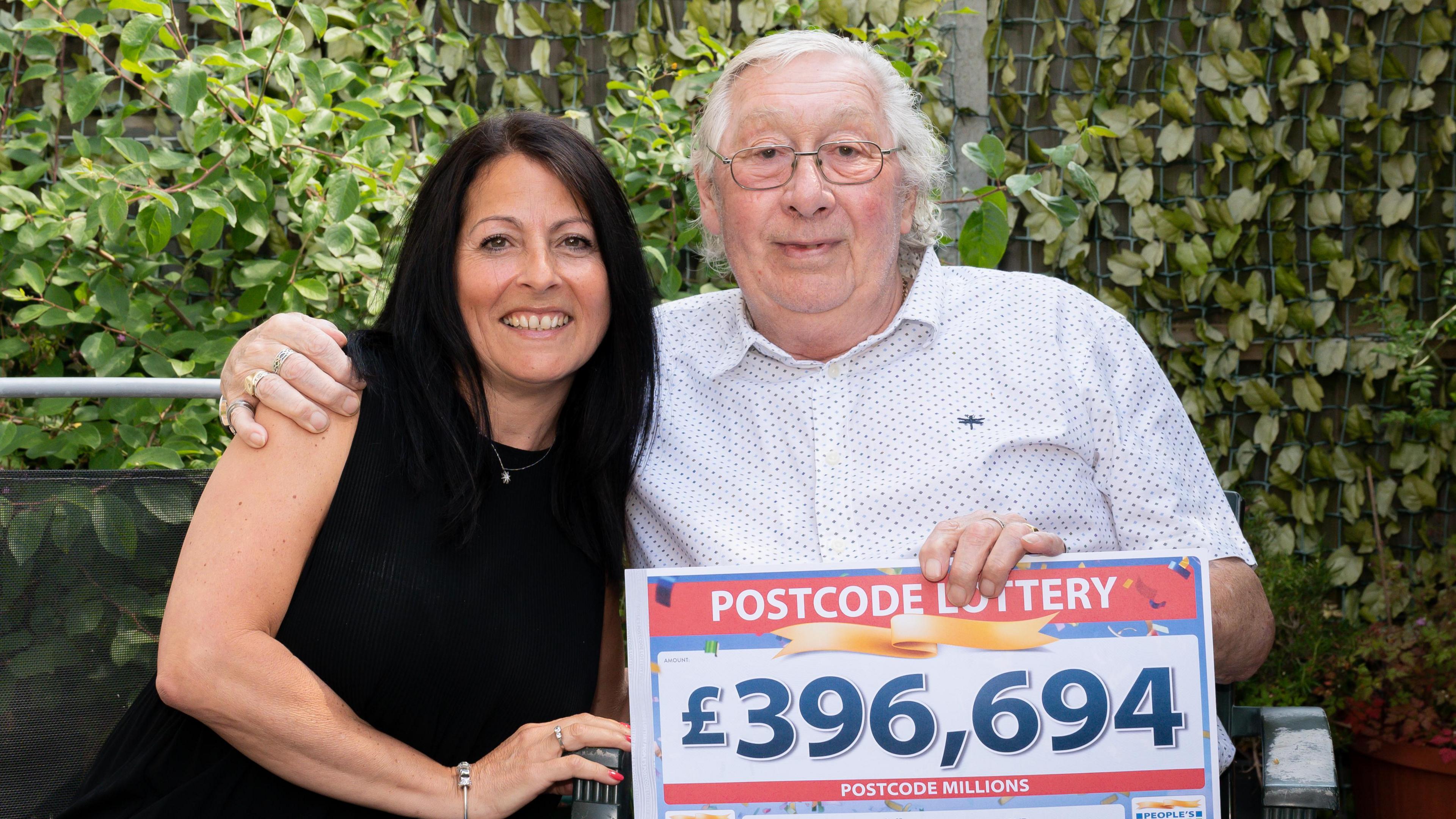 Alan with his neighbour Fiona Banks, holding a £396,694 prize sign