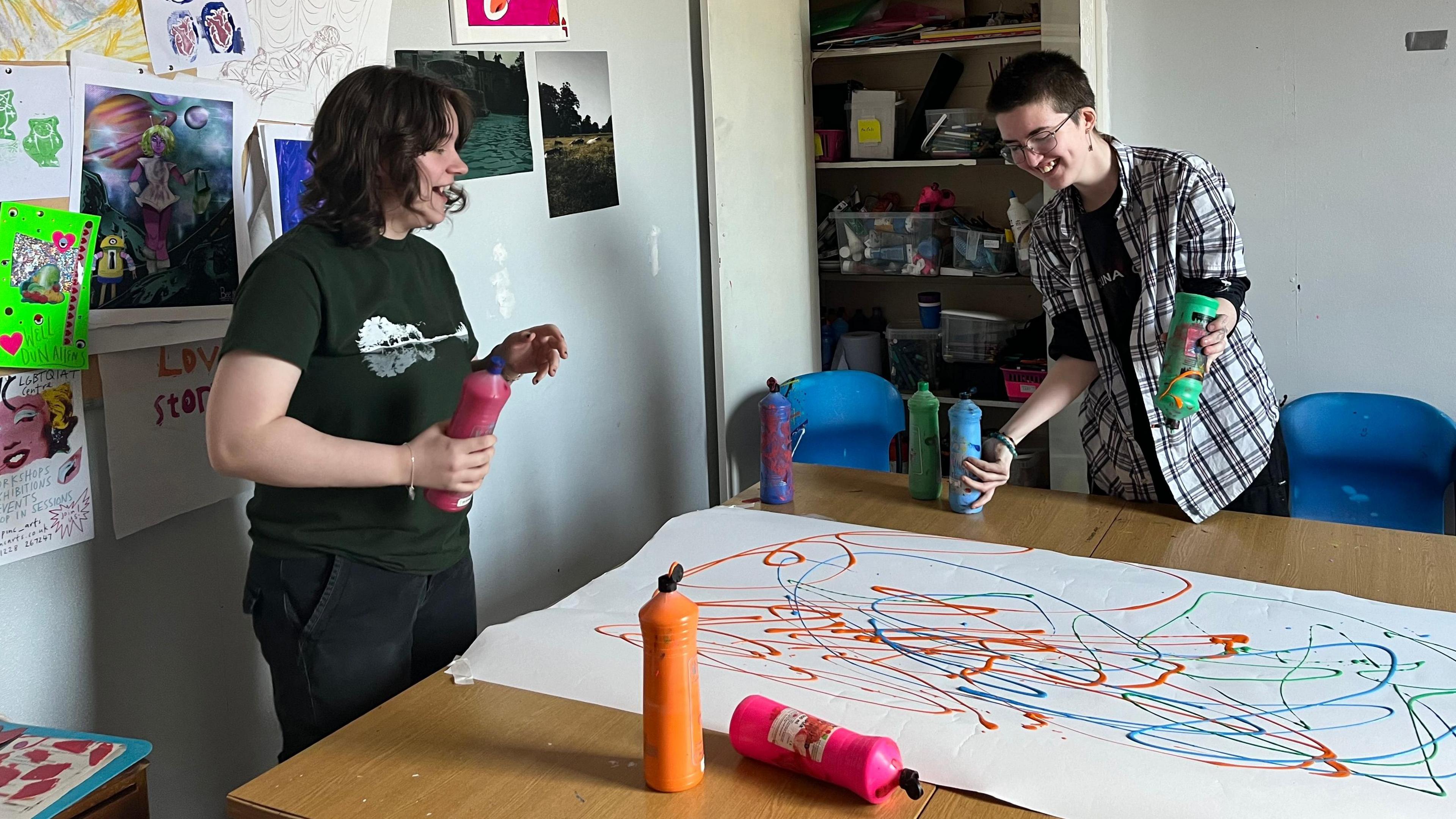 Ro and Mason creating a colourful artwork with paint