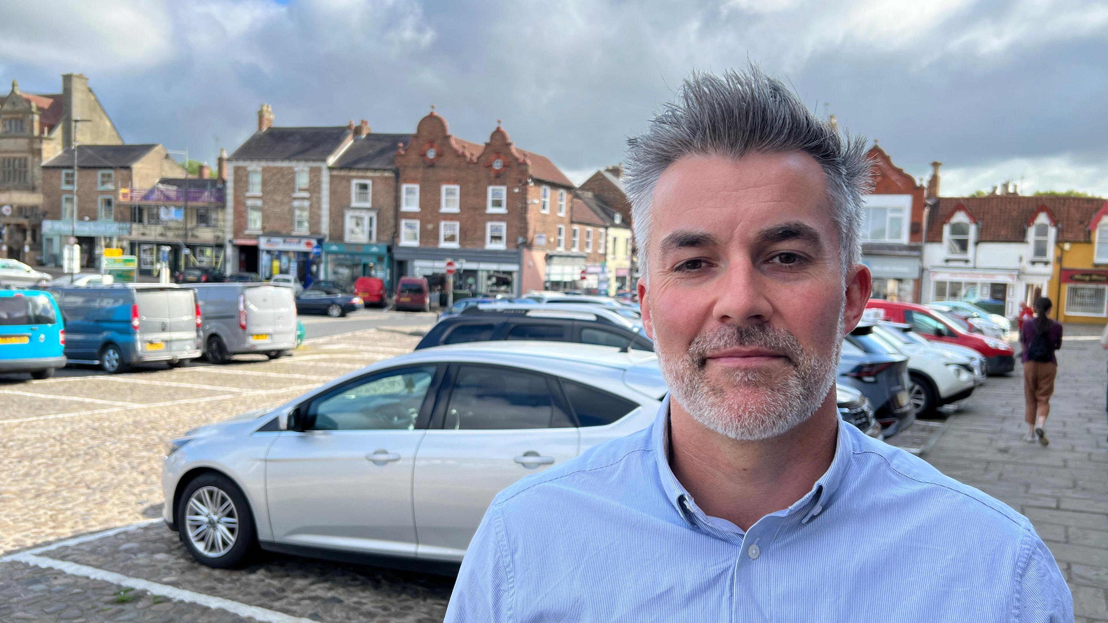 York and North Yorkshire's Labour mayor David Skaith wearing a blue shirt and standing on Thirsk's high street