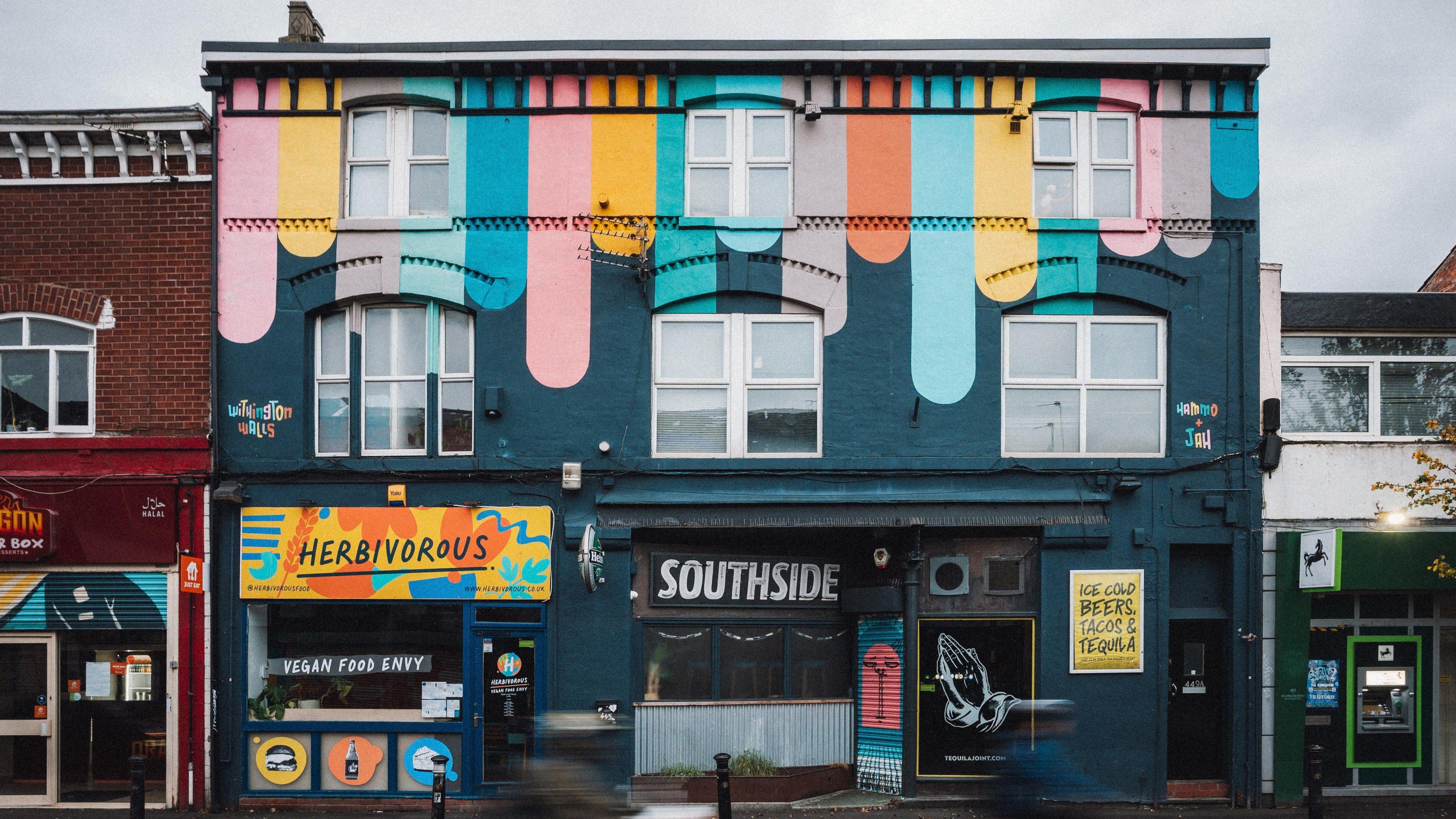 building covered in multicoloured design as part of Withington Walls Project