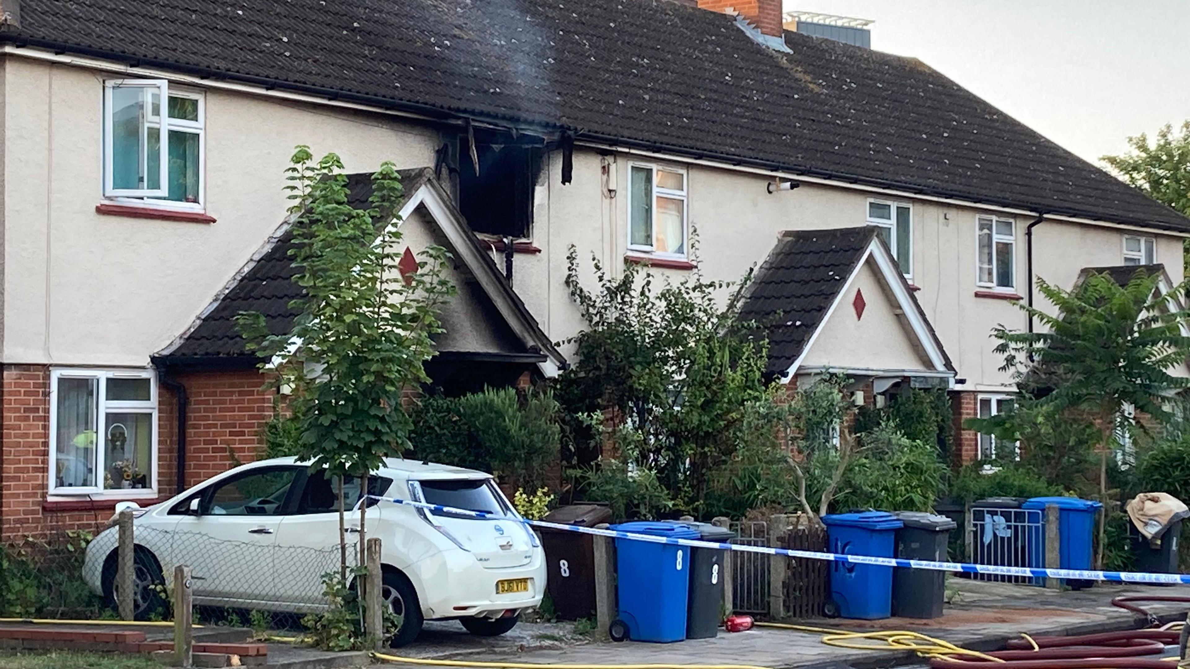 Police tape in front of a smoke-blackened house in Portman Road, Ipswich