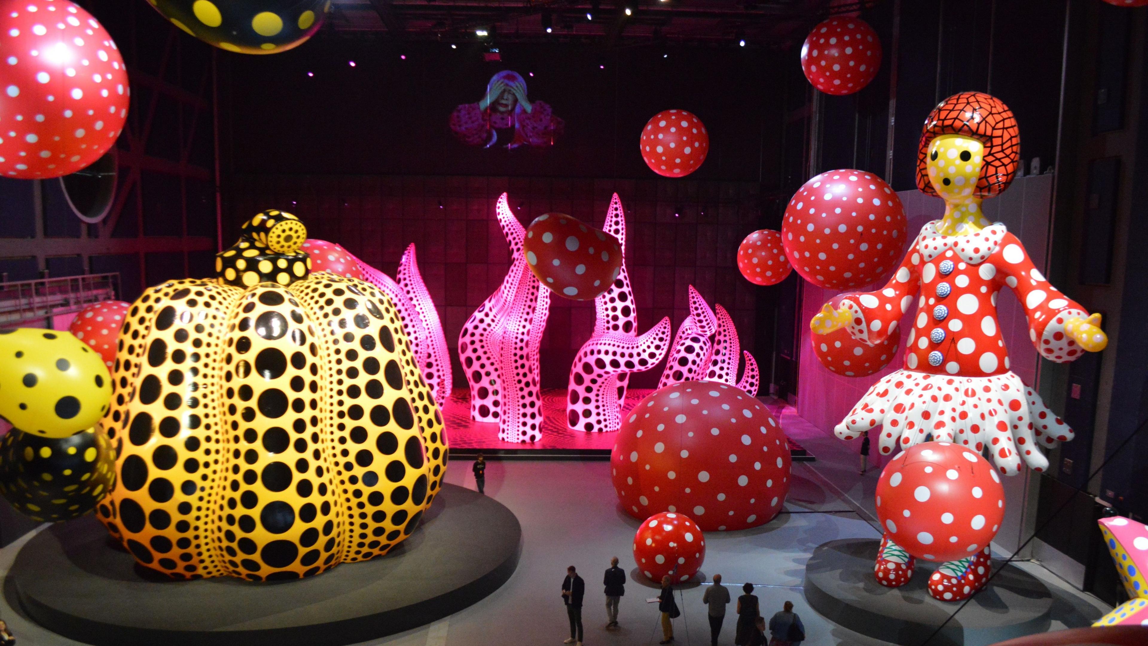 View of several of Kusama's giant colourful sculptures in Manchester.