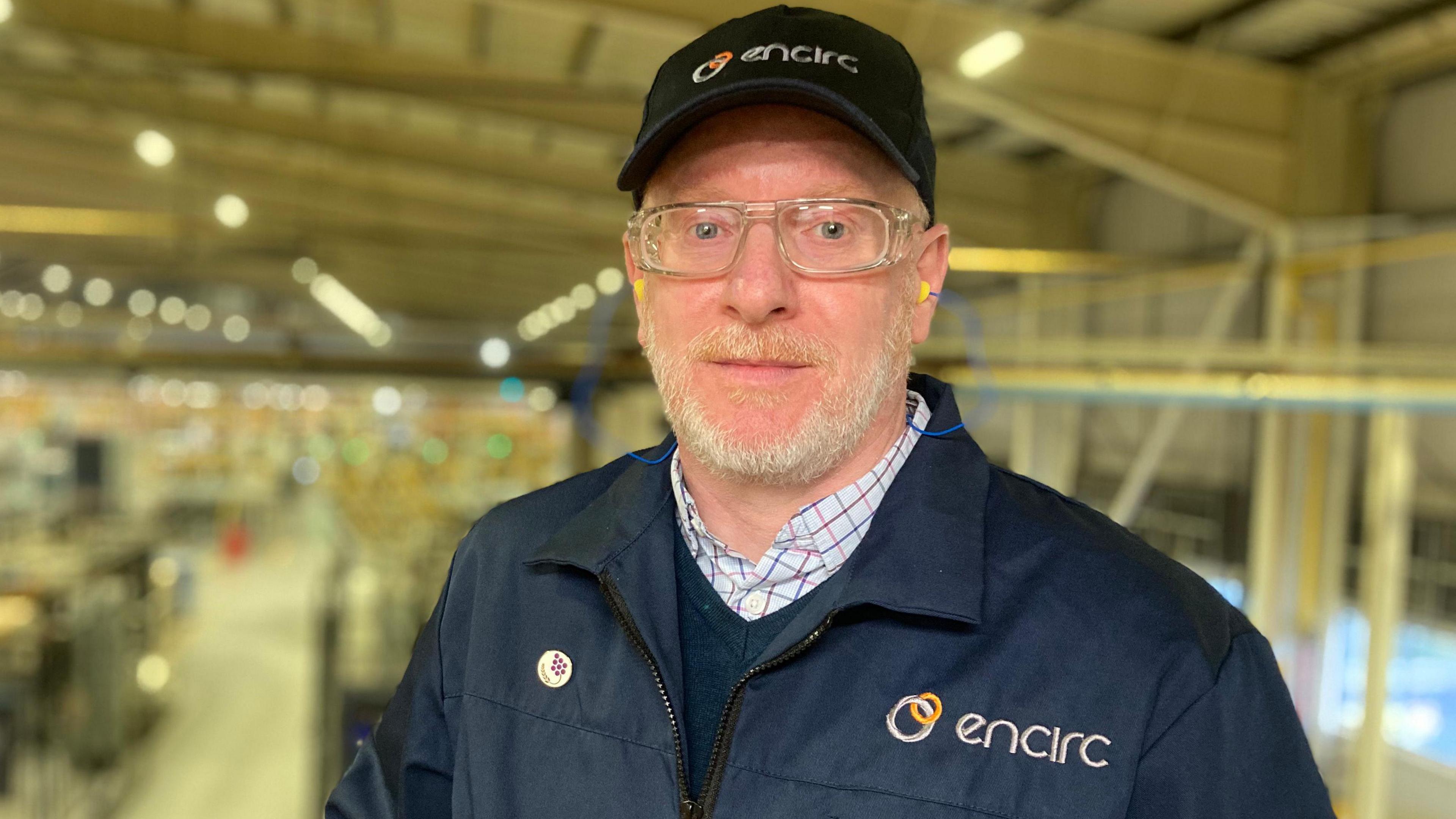 Fiacre O'Donnell stands with hat and overalls in the Encirc glass factory