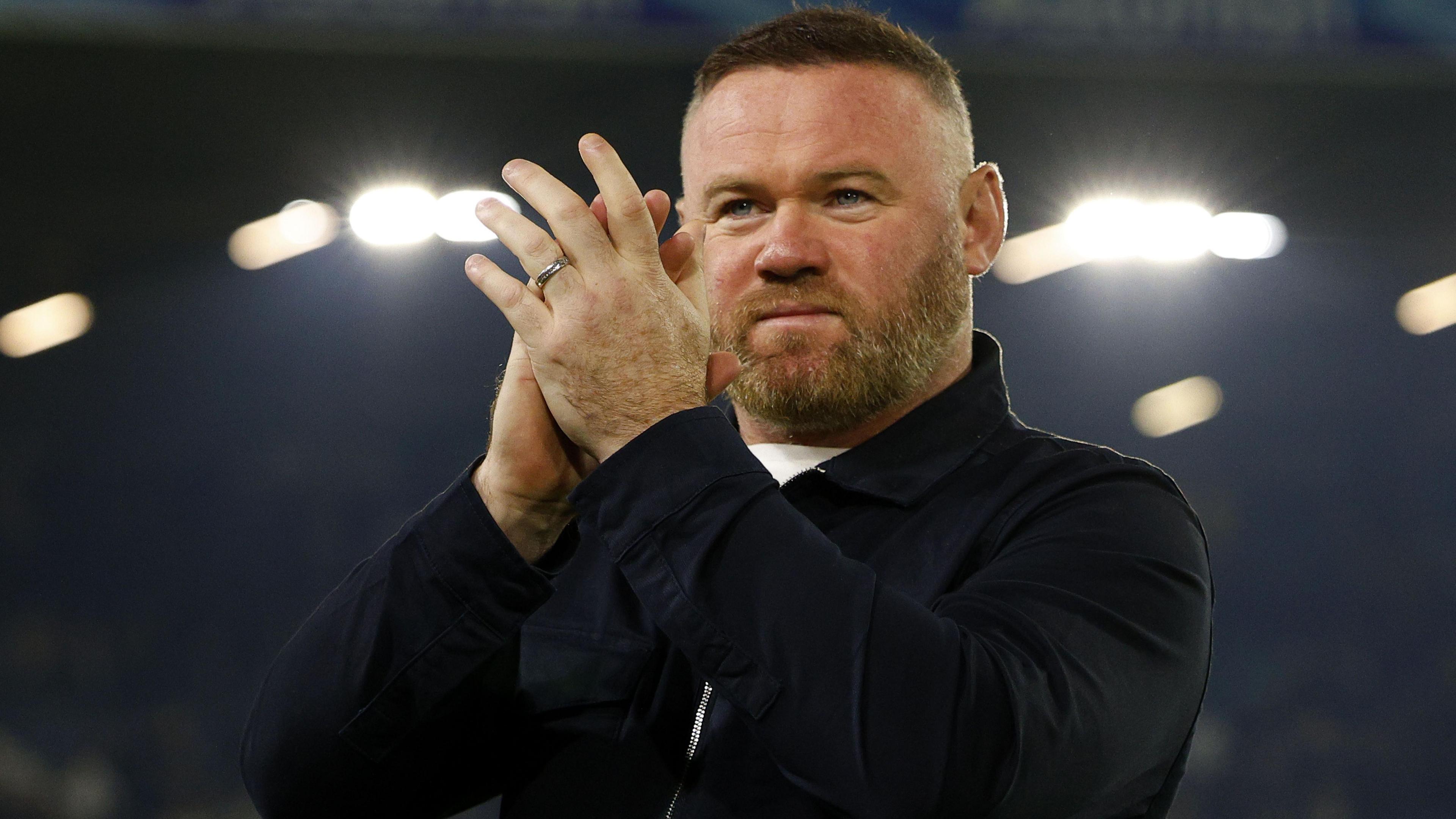 Plymouth Argyle manager Wayne Rooney applauds supporters