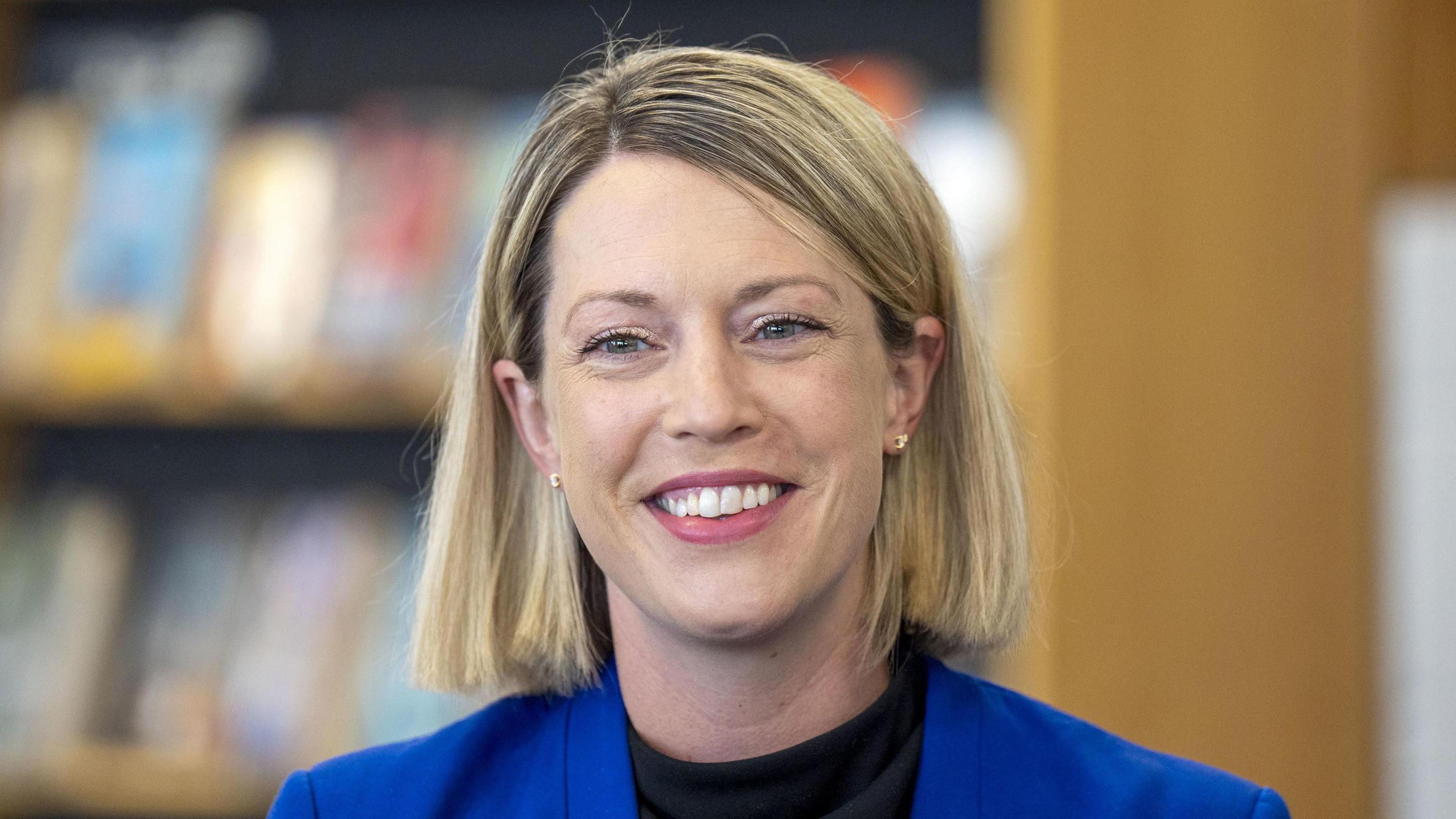 Jenny Gilruth with blonde hair and a blue suit jacket head and shoulders shot