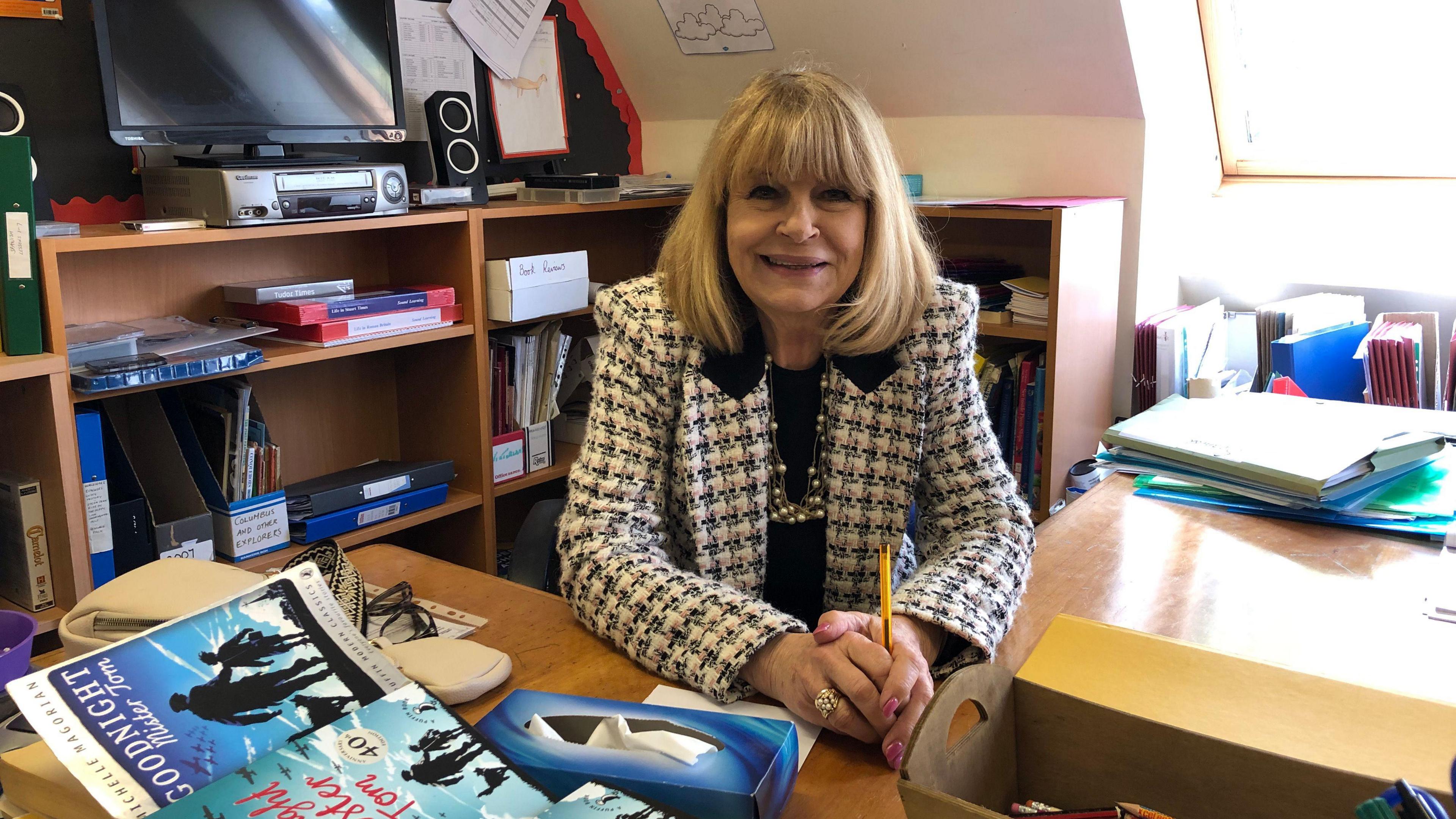 Founder and headteacher of Downham Prep School Elizabeth Laffeaty-Sharpe sitting at a desk in the History room.