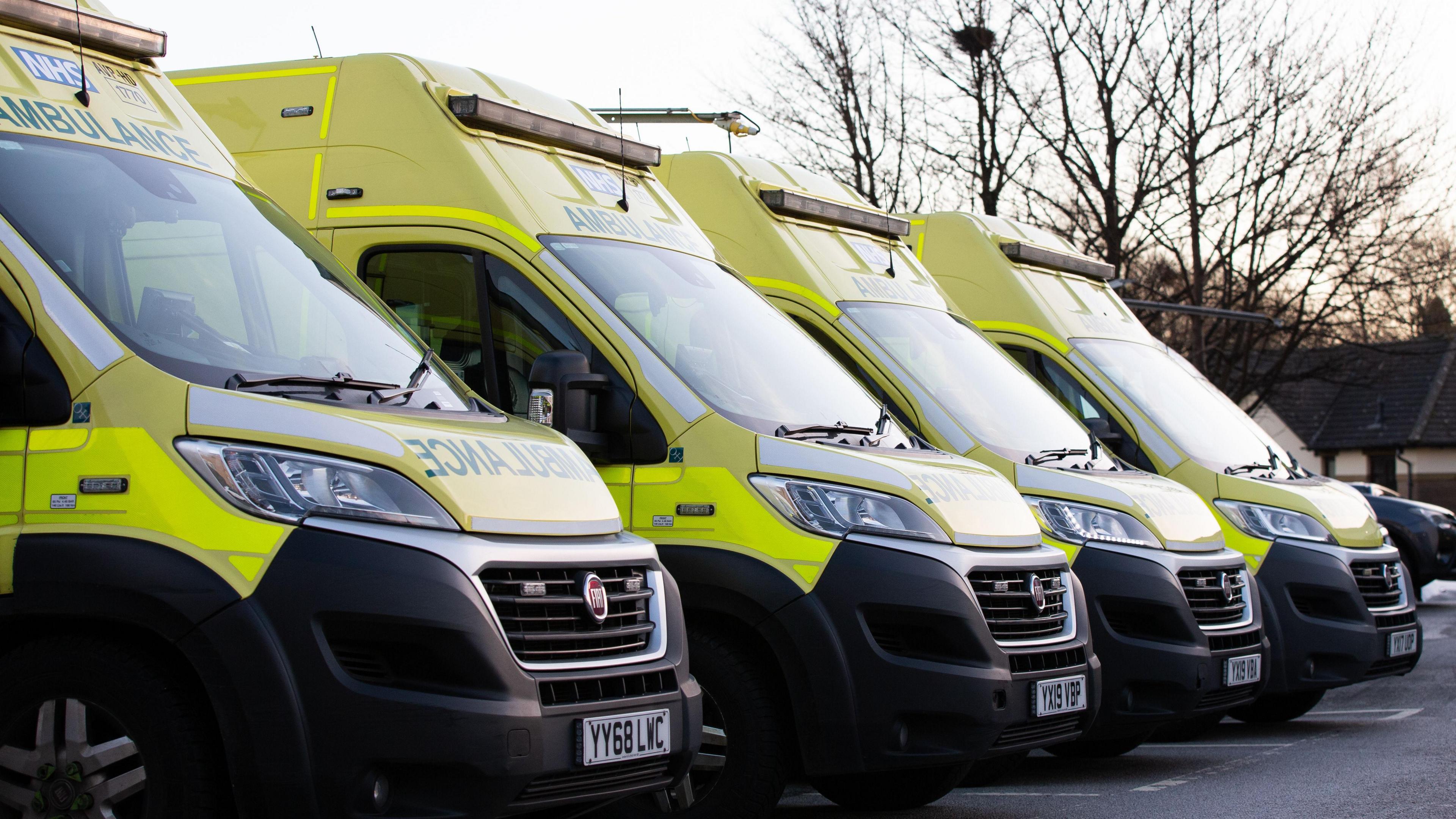 queue of parked ambulances