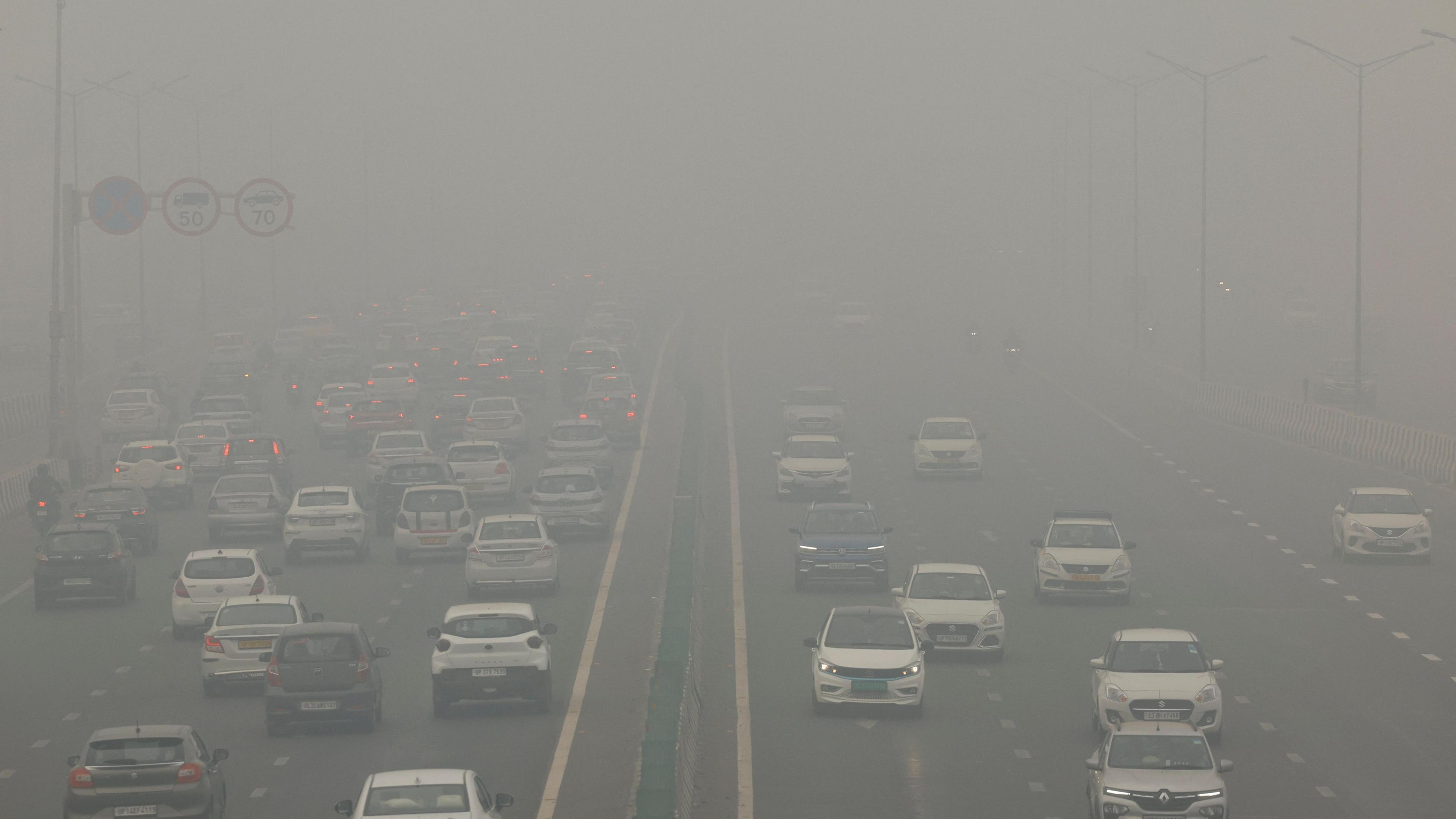 Traffic passes on a road as the sky is enveloped with smog after Delhi's air quality turned "severe" due to alarming air pollution, in New Delhi, India, November 18, 2024.