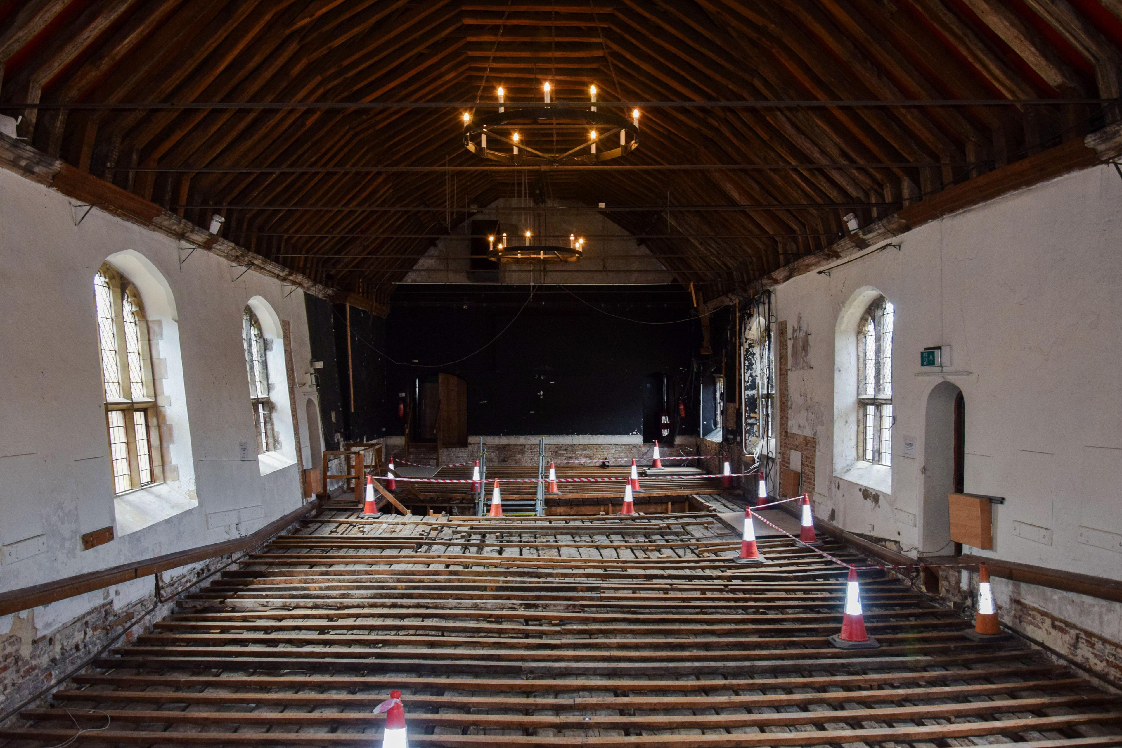 Interior of St Georges Guildhall. The floor has been taken up to show the Medieval wooden slats which would have formed the original stage. 