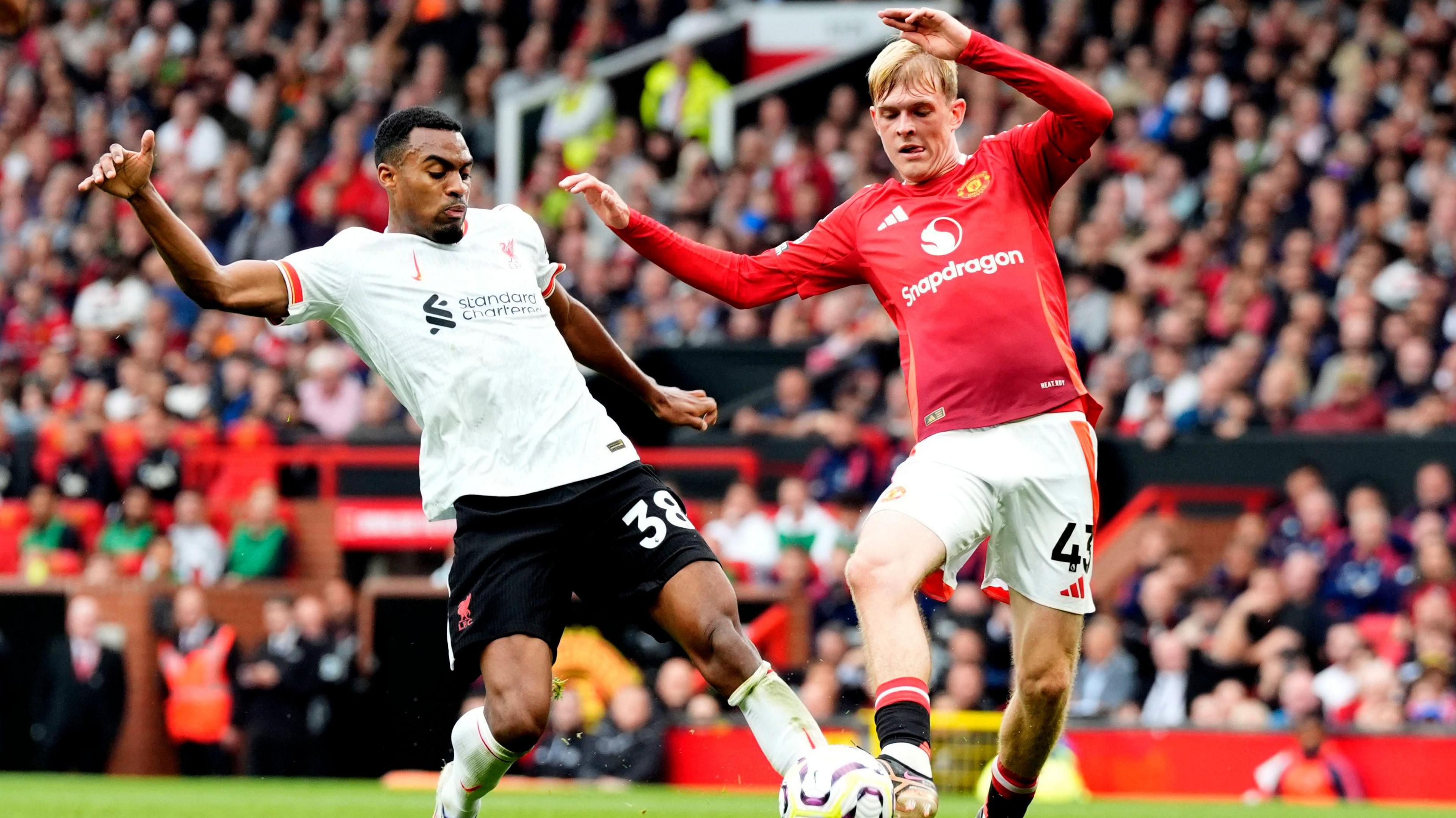 Liverpool's Ryan Gravenberch battles for possession of the ball with Manchester United's Toby Collyer, (right) during the Premier League match at Old Trafford, Manchester. 