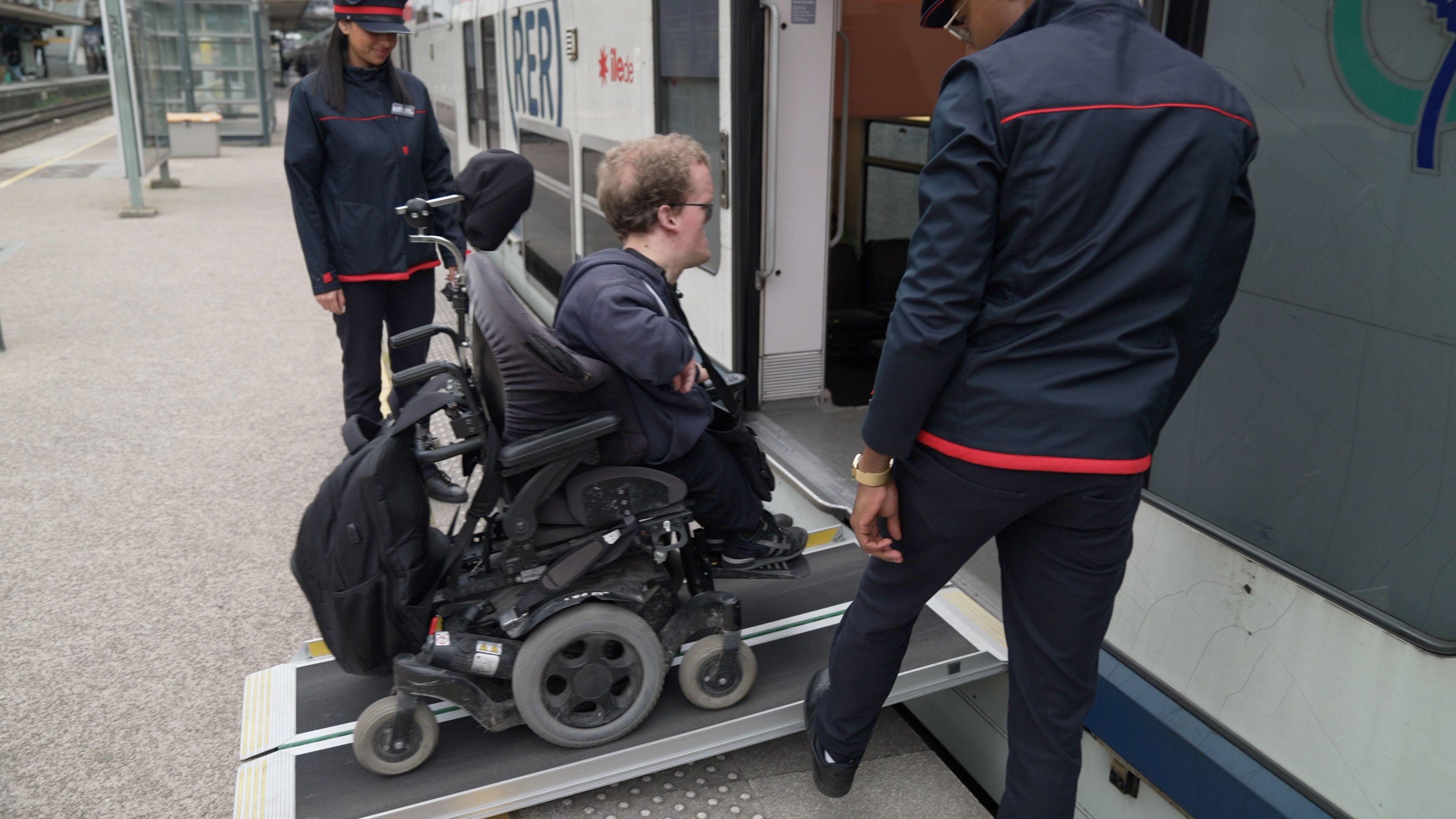 Mr Caffin uses a ramp to get on to a train at Maisons-Laffitte station