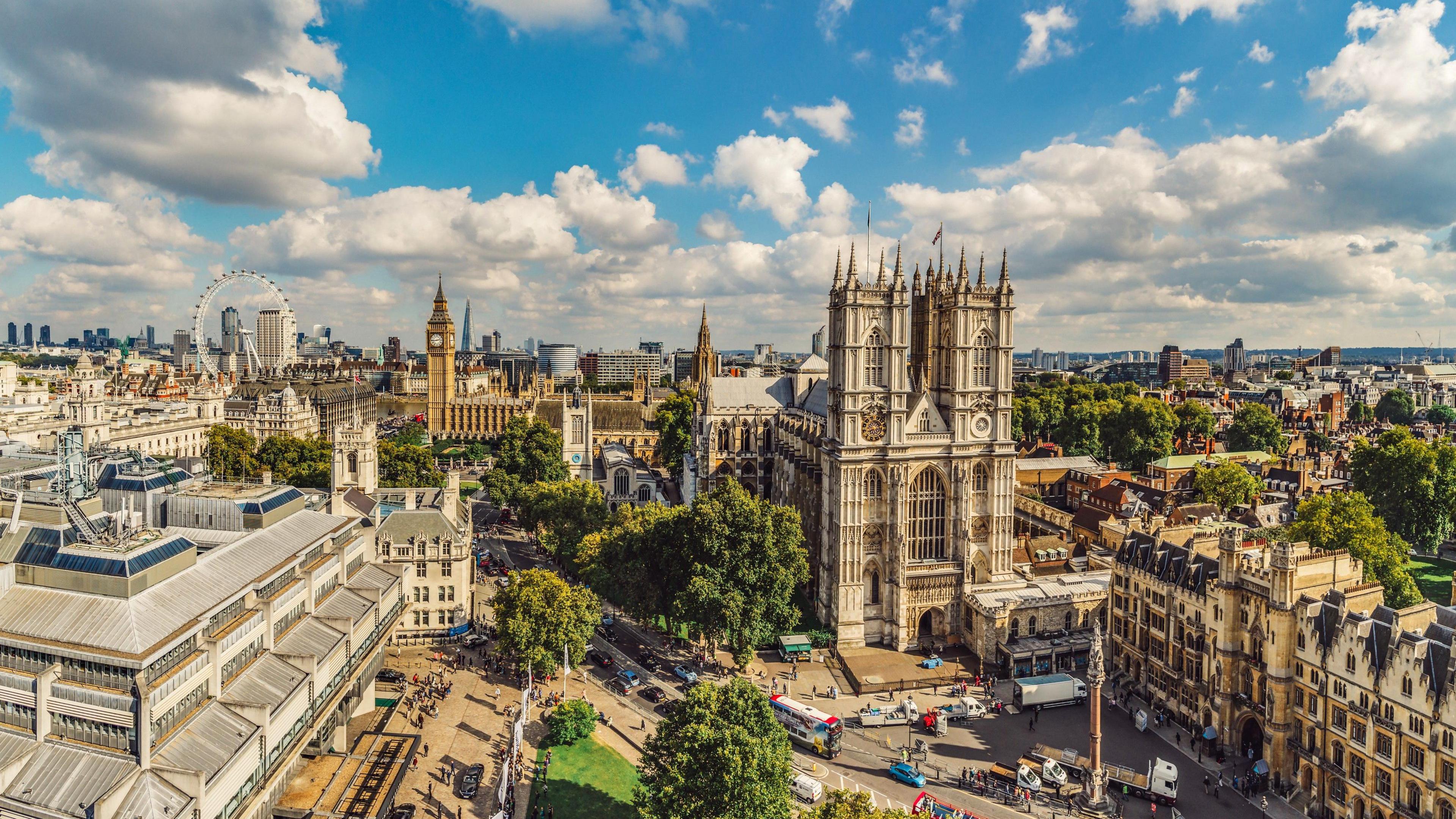 A stock photo aerial view of Westminster Abbey and Big Ben. Major sights included are Westminster Abbey, Big Ben and Houses of Parliament, the Shard, Canary Wharf and the Supreme Court.