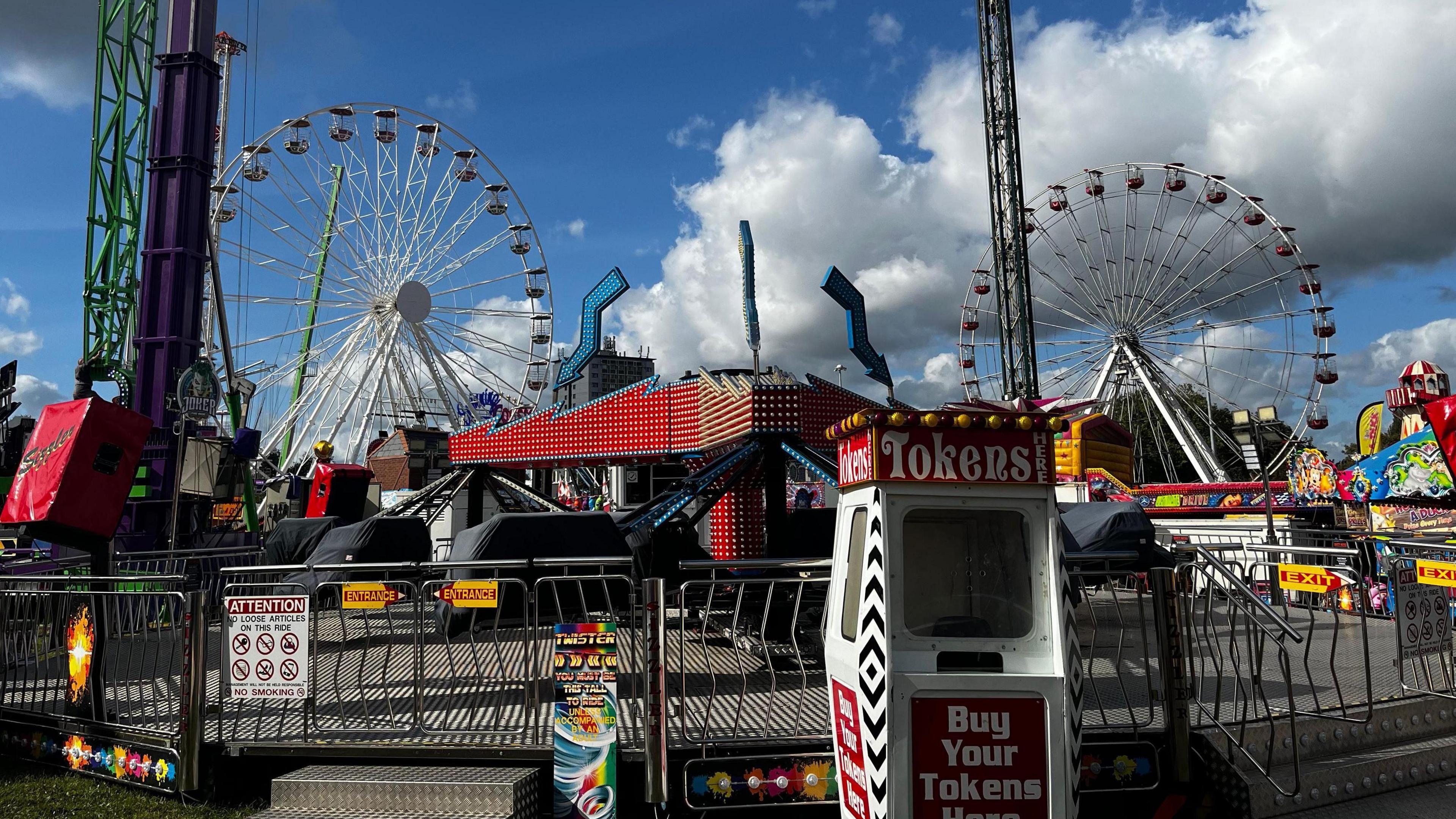 A general view of an empty Goose Fair, Nottingham, with rides and Ferris Wheels in the background 