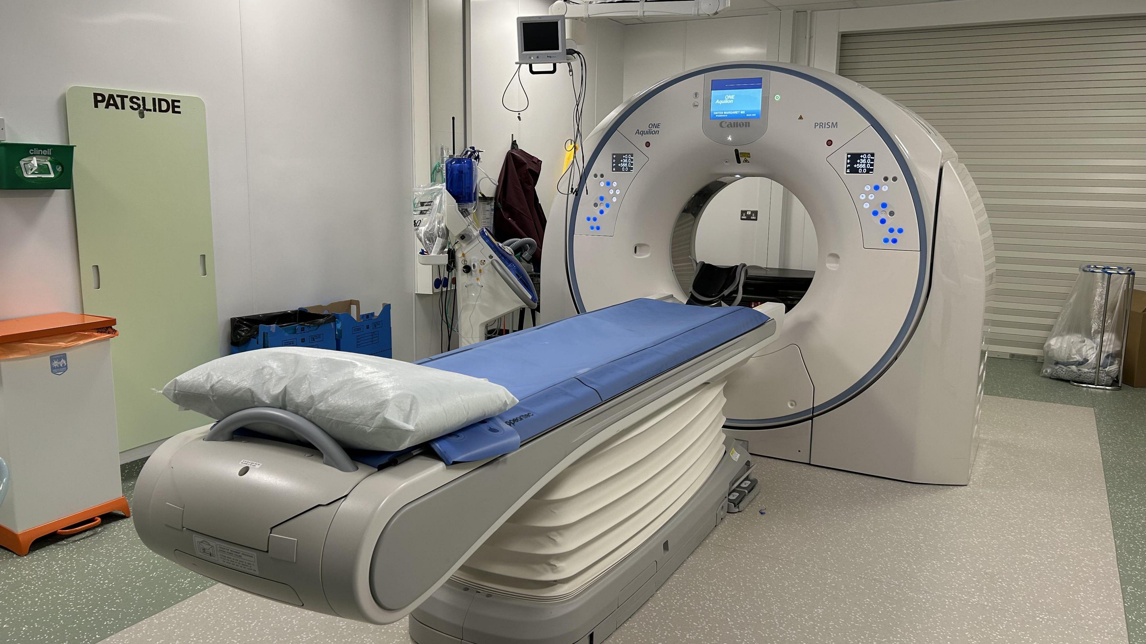 A CT scanner with the donut style scanner which the bed can move through.
