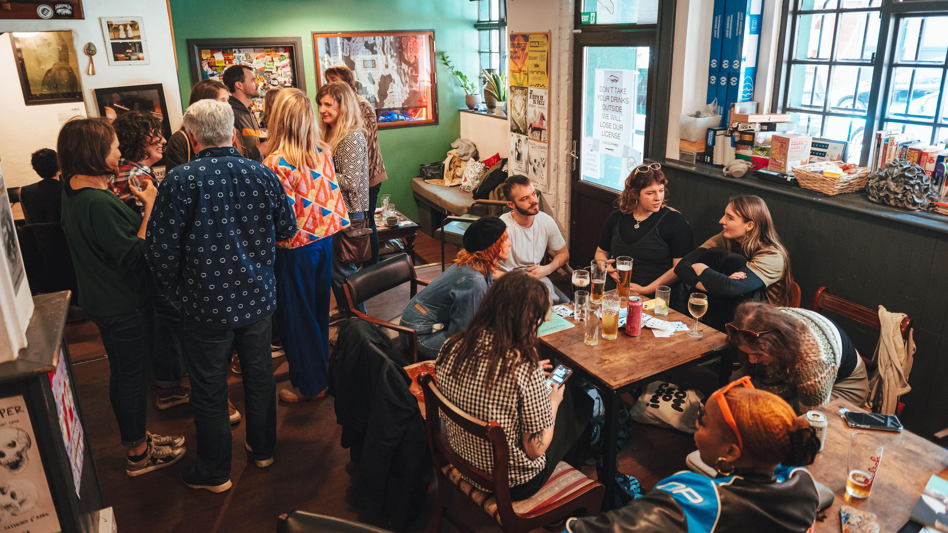 Groups of people gathered in a small pub