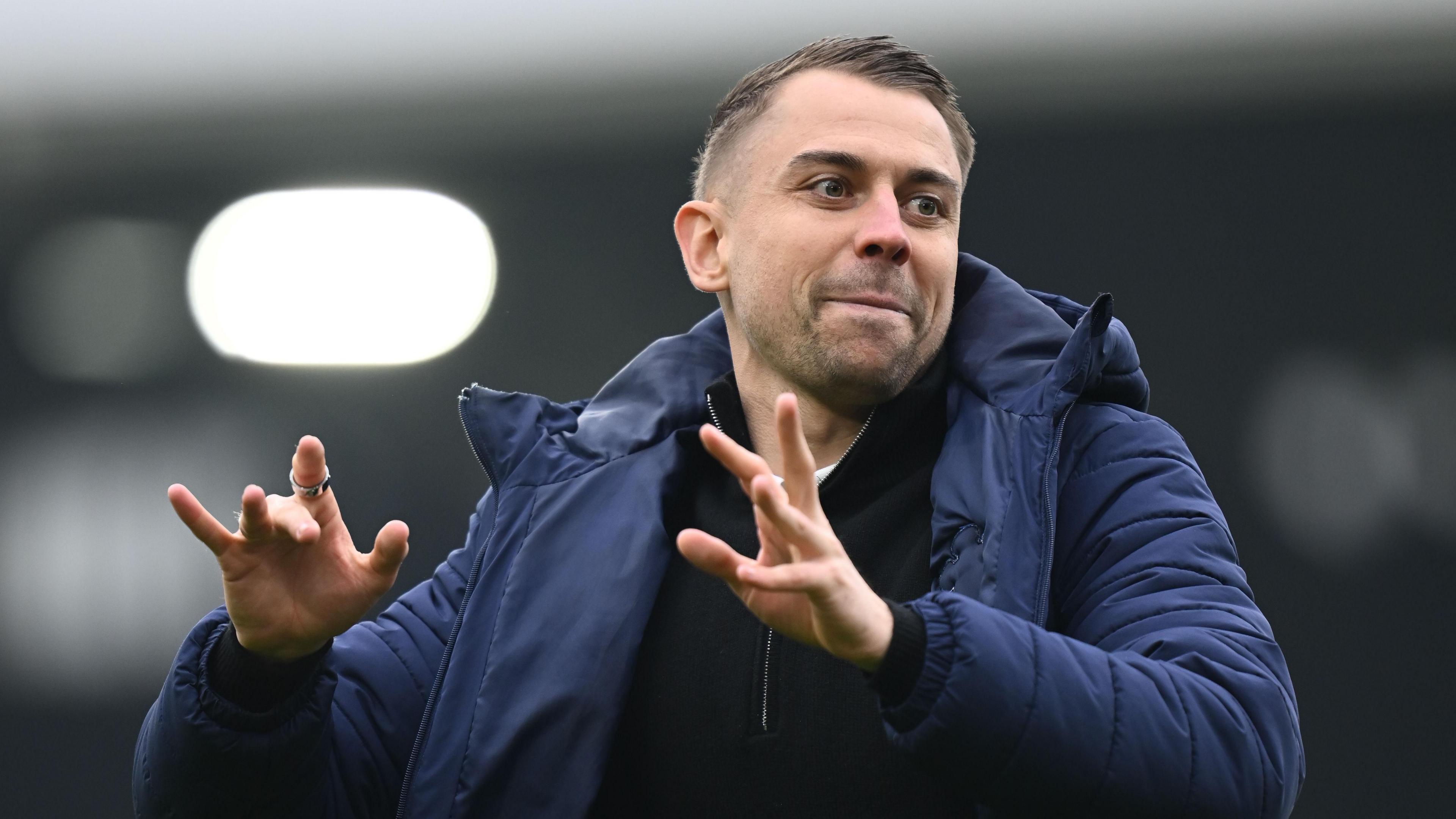 Southampton manager Tonda Eckert has his hands out in front of him with beaming smile