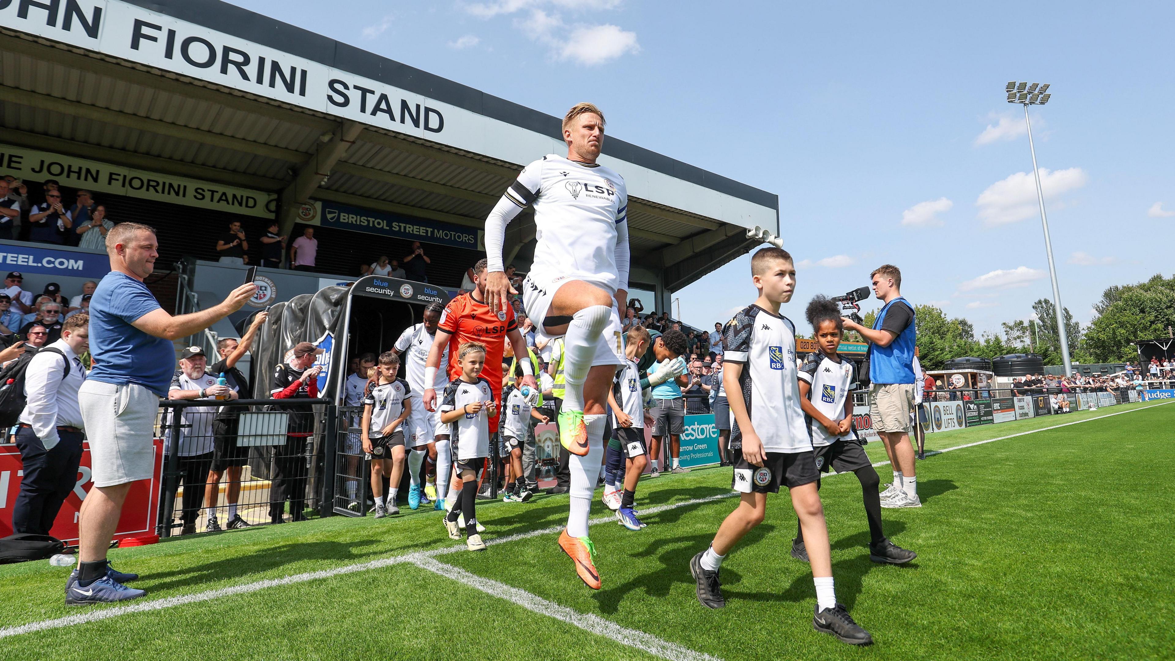 Bromley captain Byron Webster leading his team out of the player tunnel against Harrogate Town