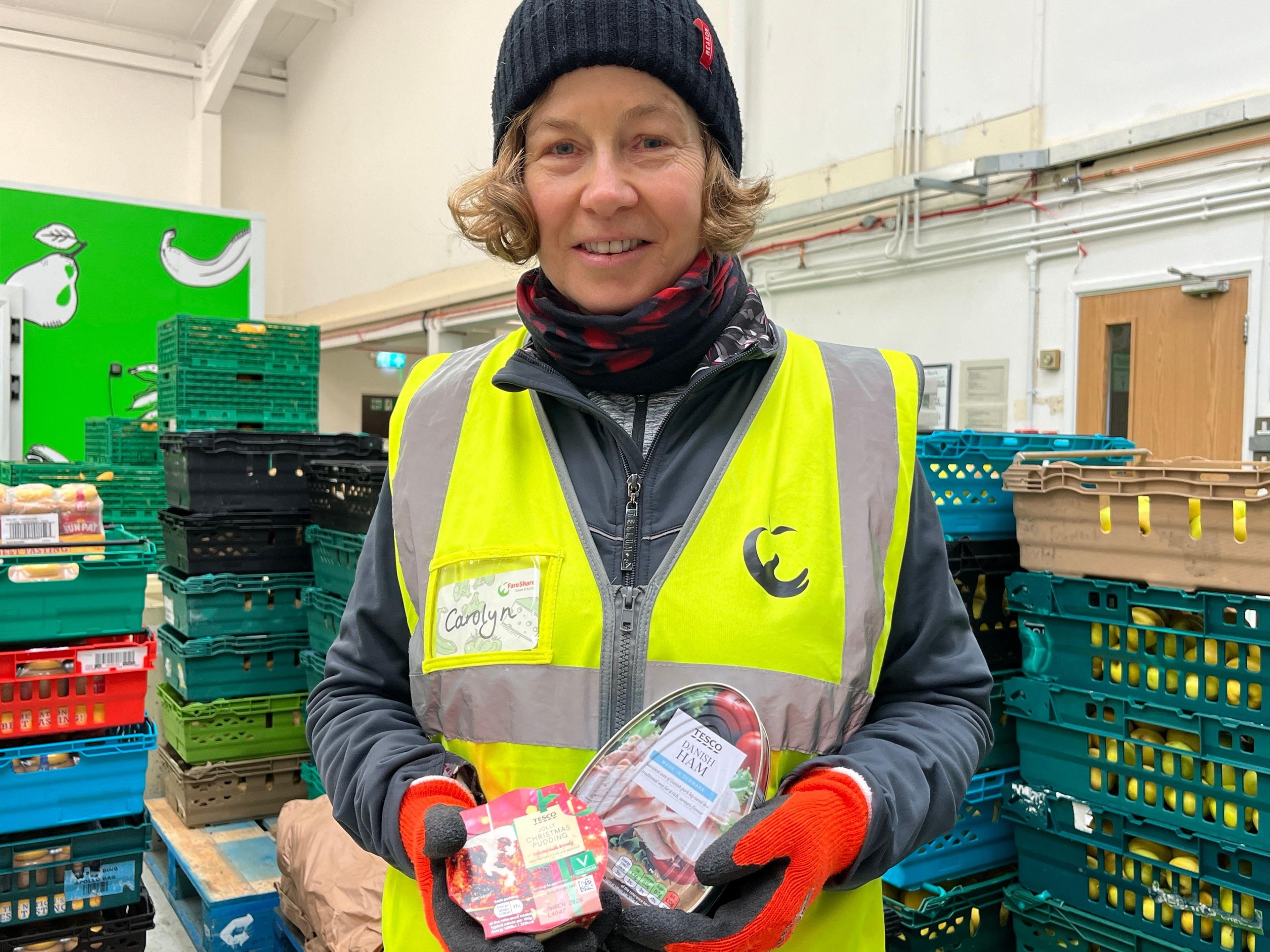 A volunteer holds donate Christmas food.