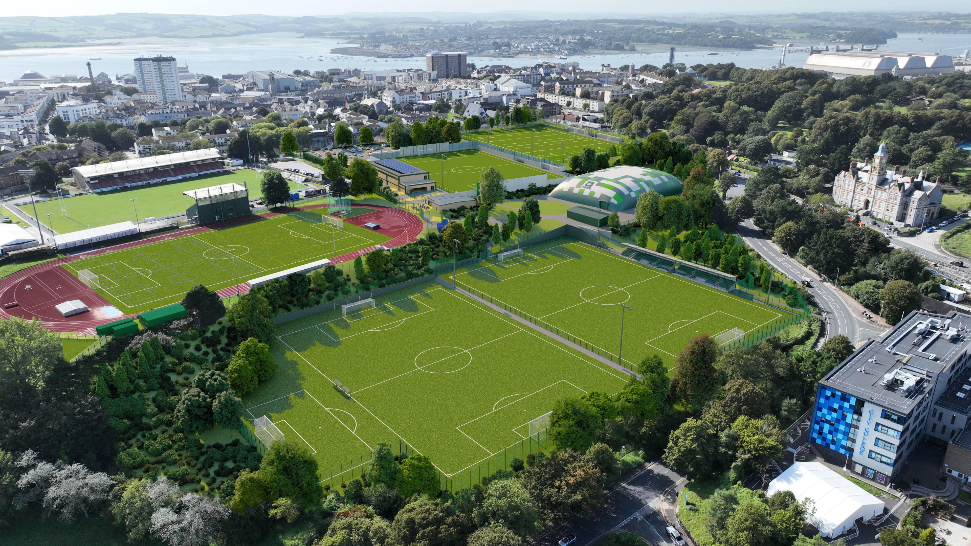 A computer-generated imagery (CGI) of the proposed development. There are a total of 5 football pitches in view. Two are next to each other in the middle of the photo. One pitch is in the left side of the image, it is surrounded by a racing track and backs on to an existing rugby field used by Plymouth Albion RFC. To the right of the picture there is a green and white chequered sports dome with the Plymouth Argyle logo on the front of it. In the distance there are two more football pitches next to one another.