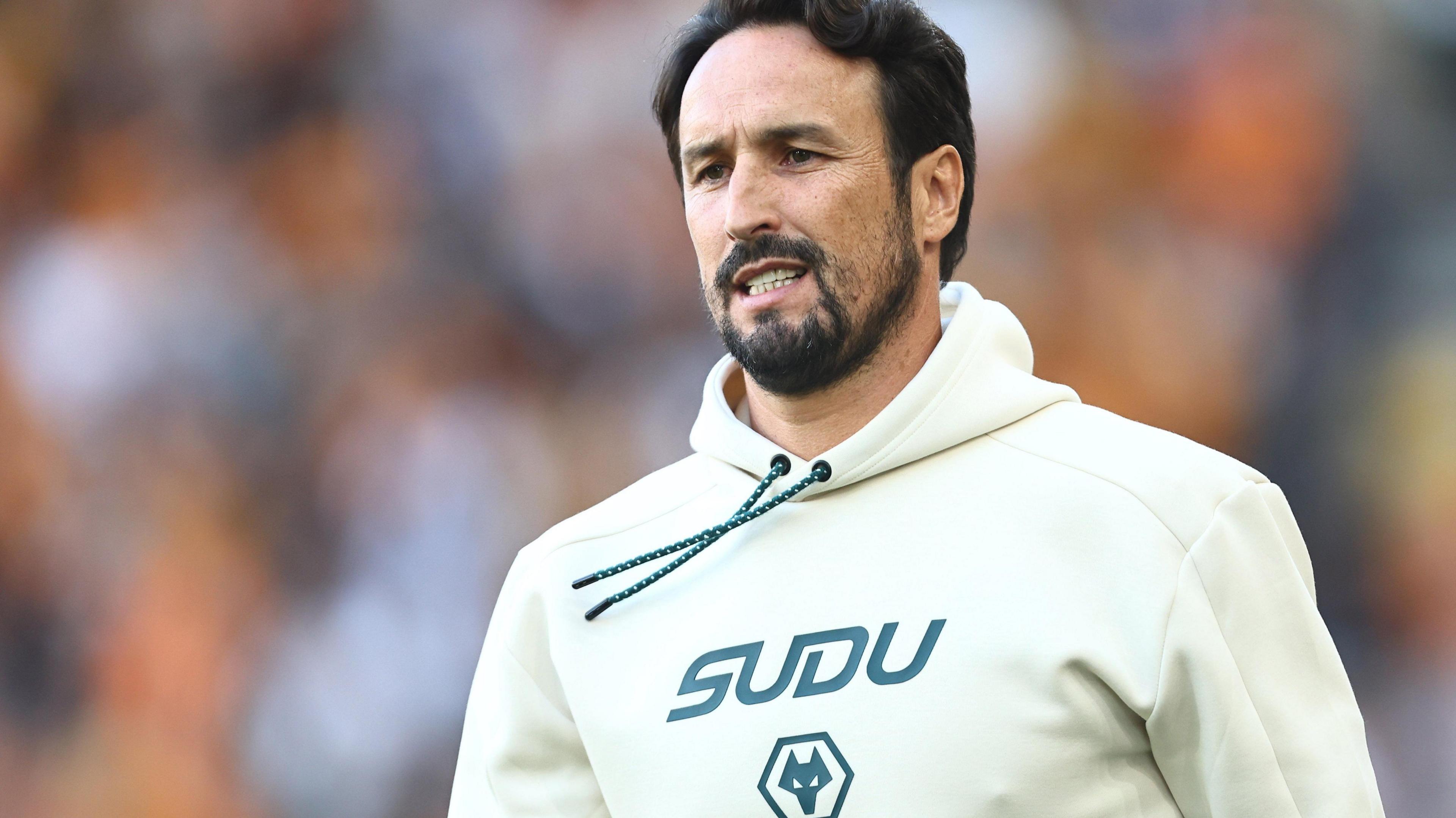 Cesar Peixoto watches from the sidelines in a Wolves hoodie