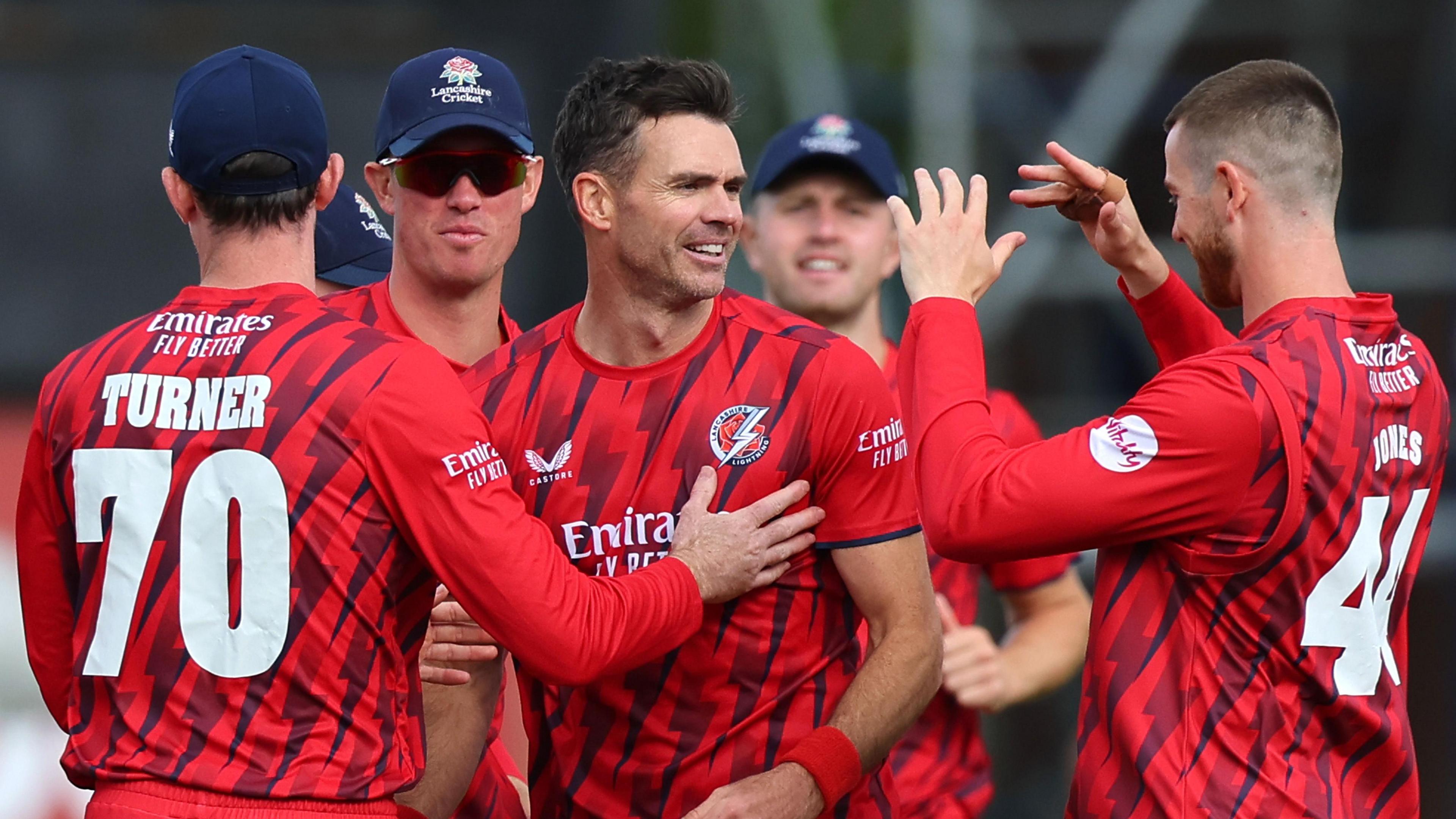 Jimmy Anderson (centre) is congratulated by four Lancashire players for taking a wicket in the T20 Blast