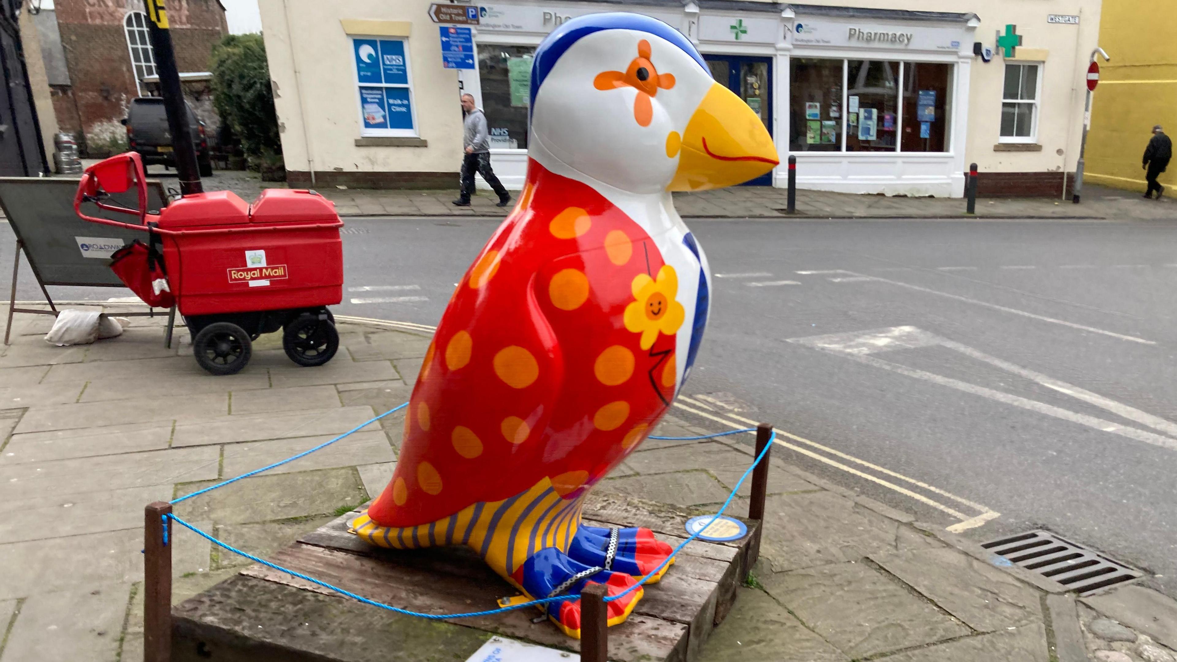 a brightly coloured puffin statue