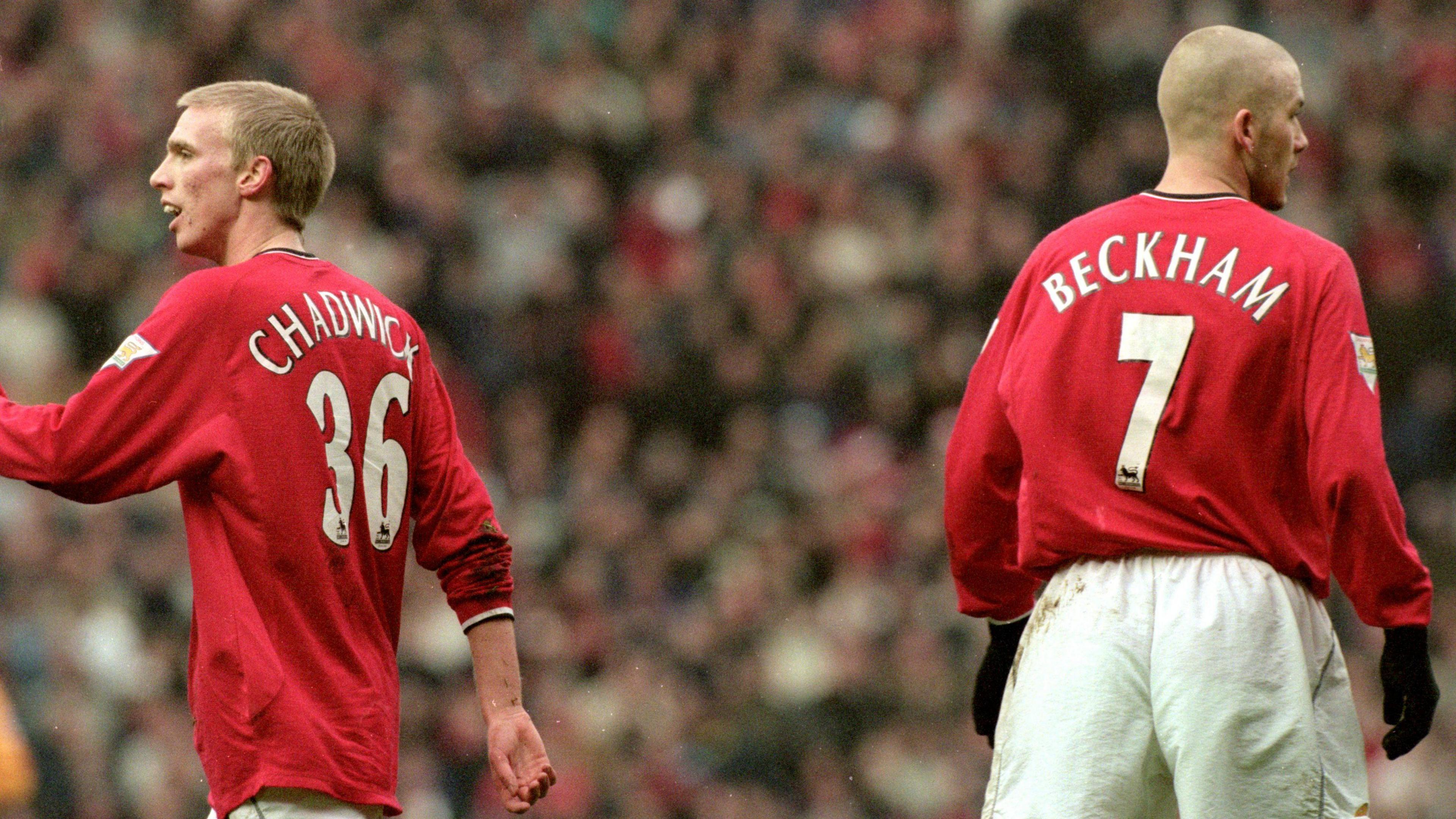 Luke Chadwick, picture mid stride wearing his number 36 Manchester United shirt. David Beckham, to the right of Chadwick, is facing away from camera, with his Red Manchester United number 7 shirt on full display.
