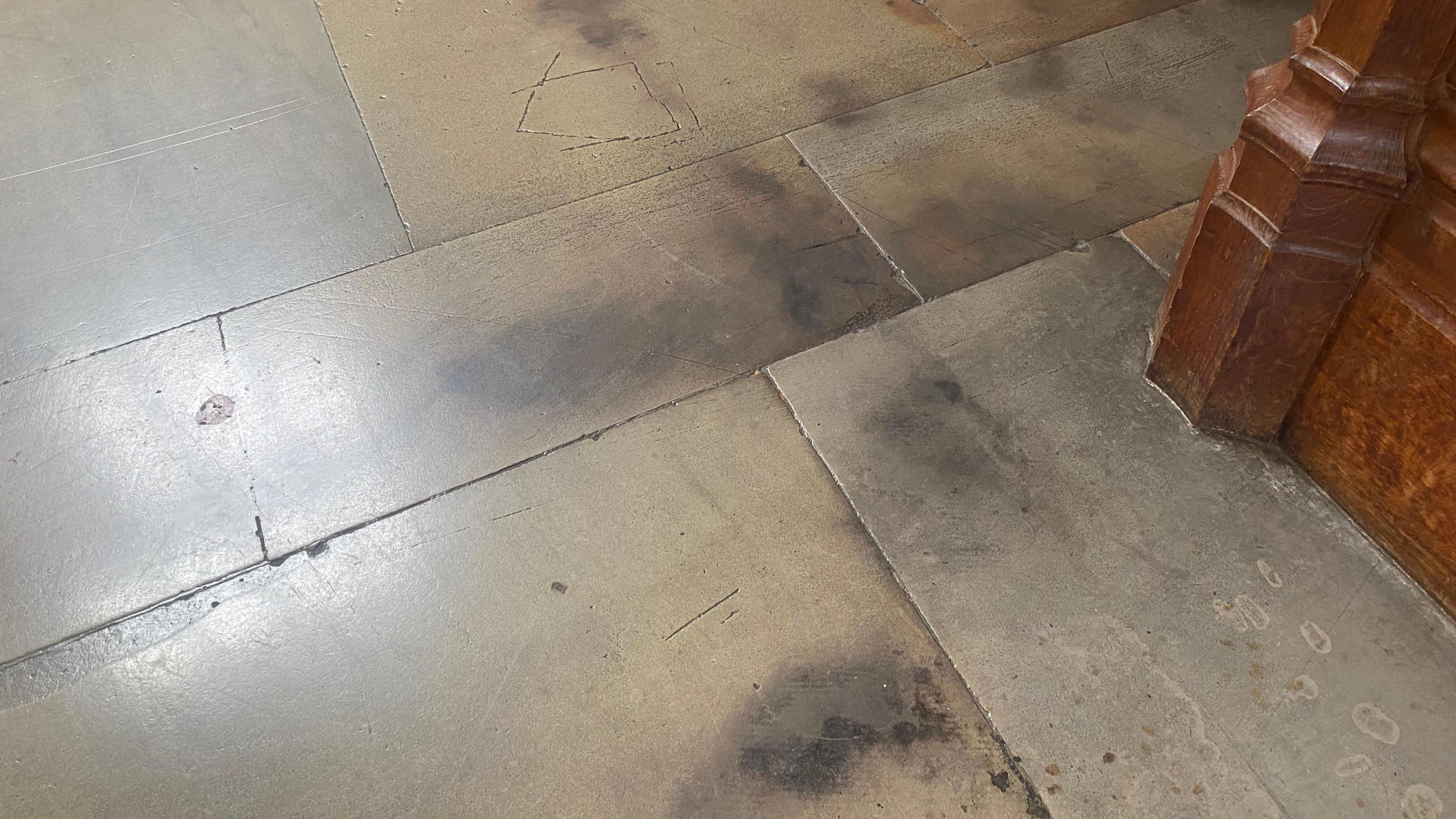 Black marks stain the stone floor of the Wills Memorial Building's Great Hall