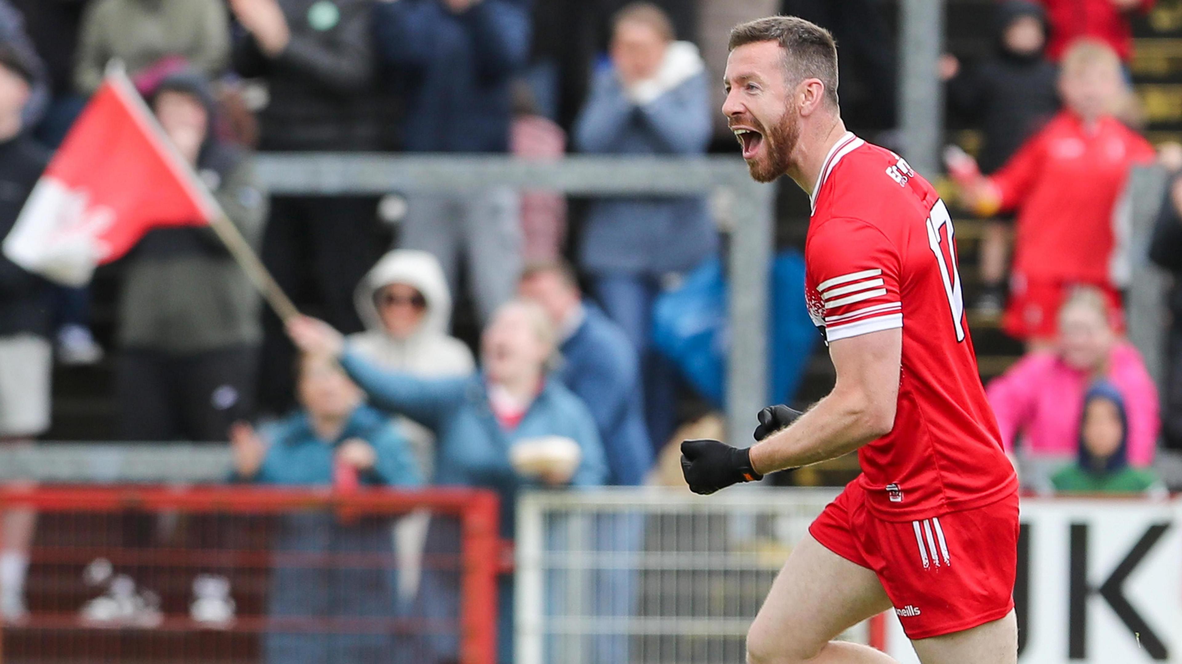 Niall Loughlin celebrates scoring a goal for Derry in a game at Celtic Park