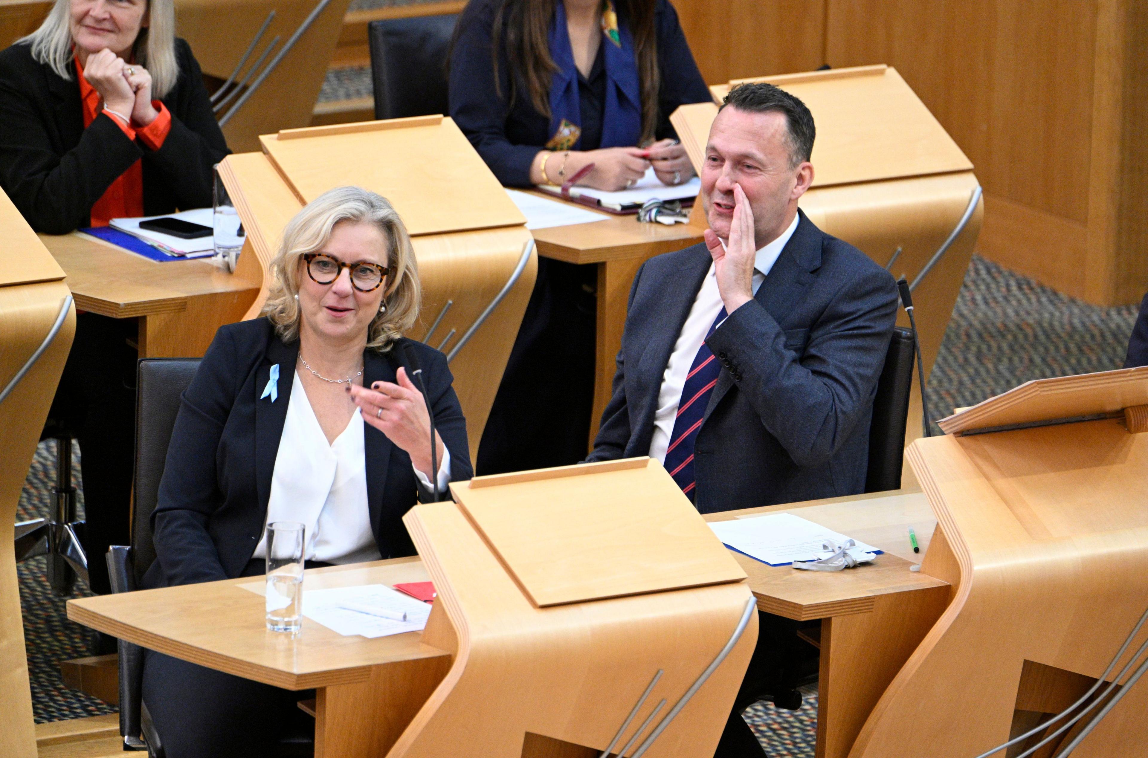 Russell Findlay and colleagues apparently good-naturedly shouting across the chamber at the first minister. He is smiling while holding his hand to his mouth to be heard