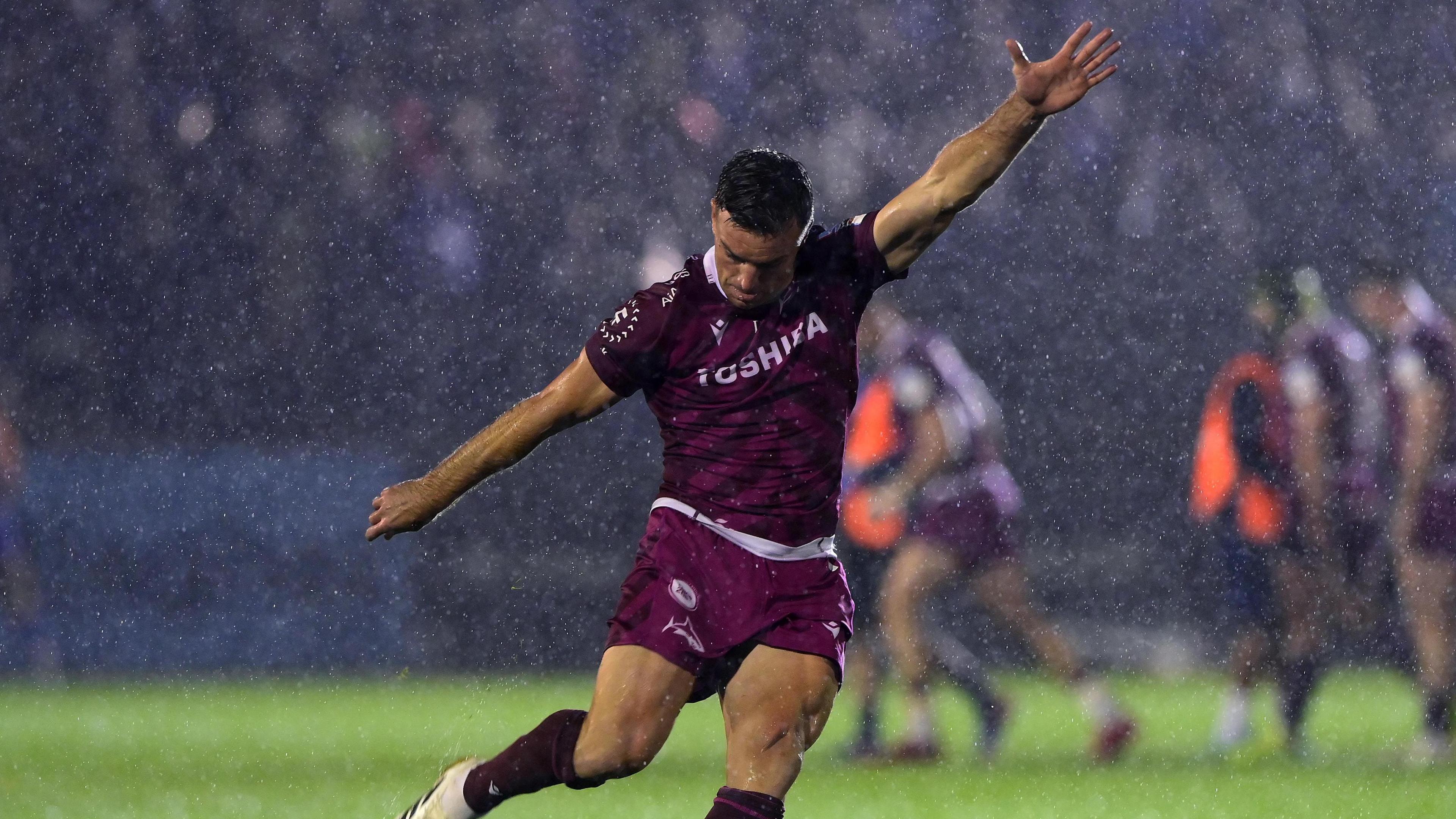 George Ford holds his arms out and draws his leg back to kick a penalty