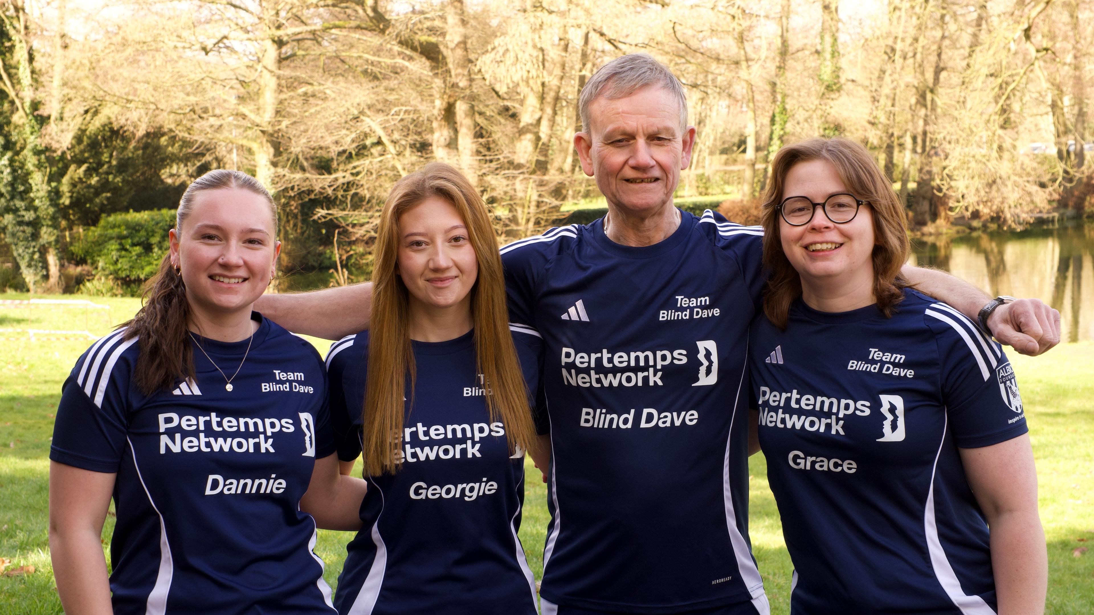 Four people wearing navy running gear. The outfits have their names and Pertemps Network written on them. The names are Dannie, Georgie, Blind Dave and Grace