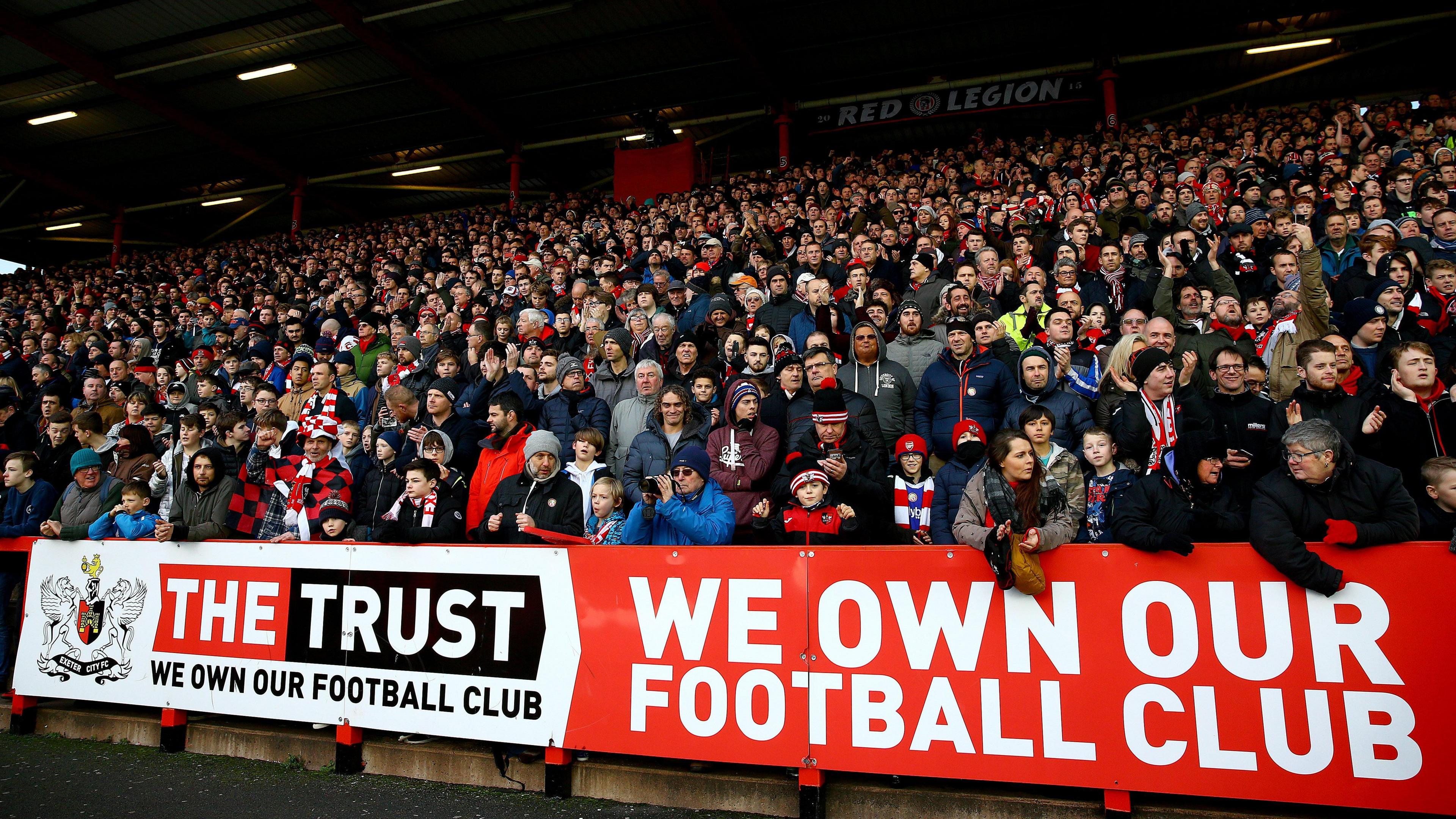 Exeter City fans banner reading 'we own our football club'