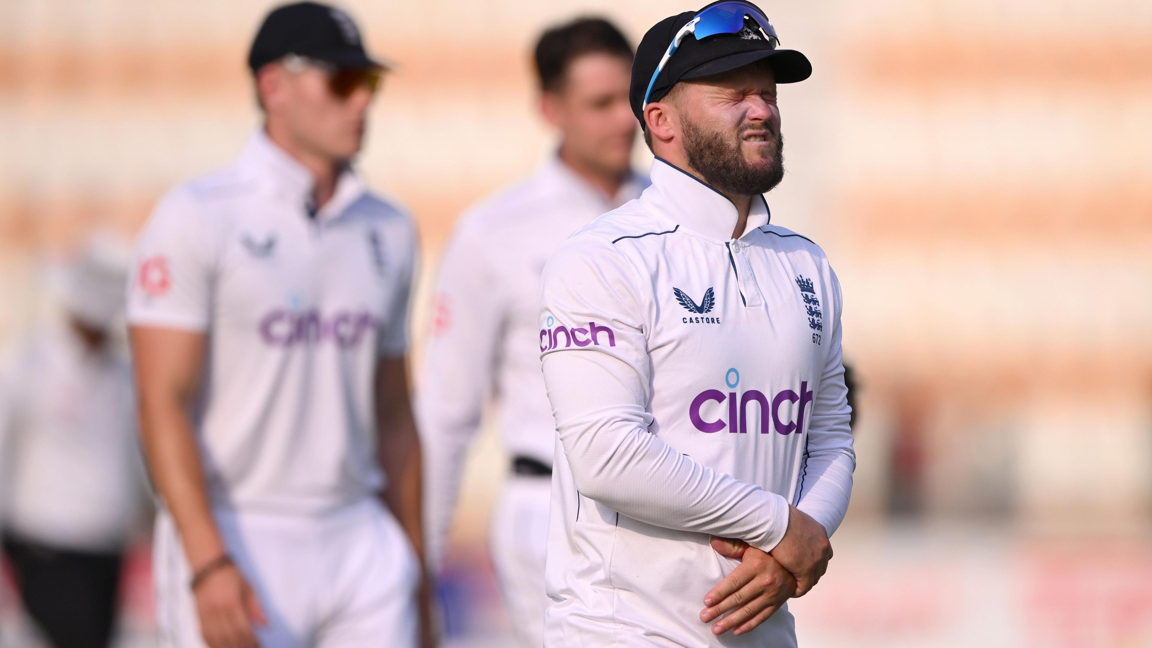 Ben Duckett holds his left wrist after taking a blow when taking a catch