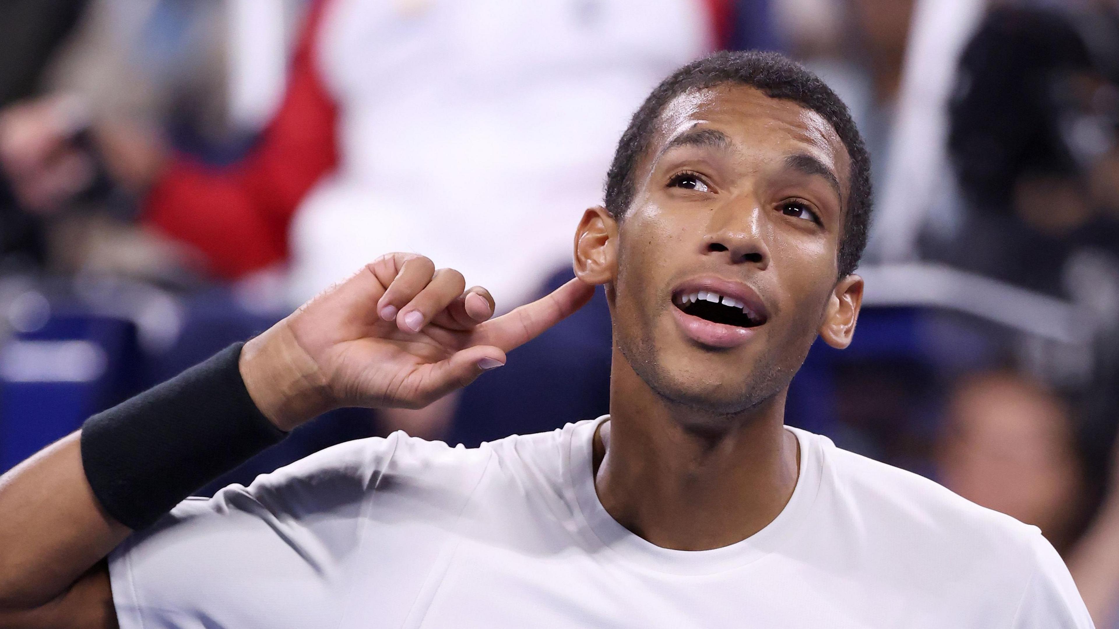 Felix Auger-Aliassime points to his ear at the 2025 US Open