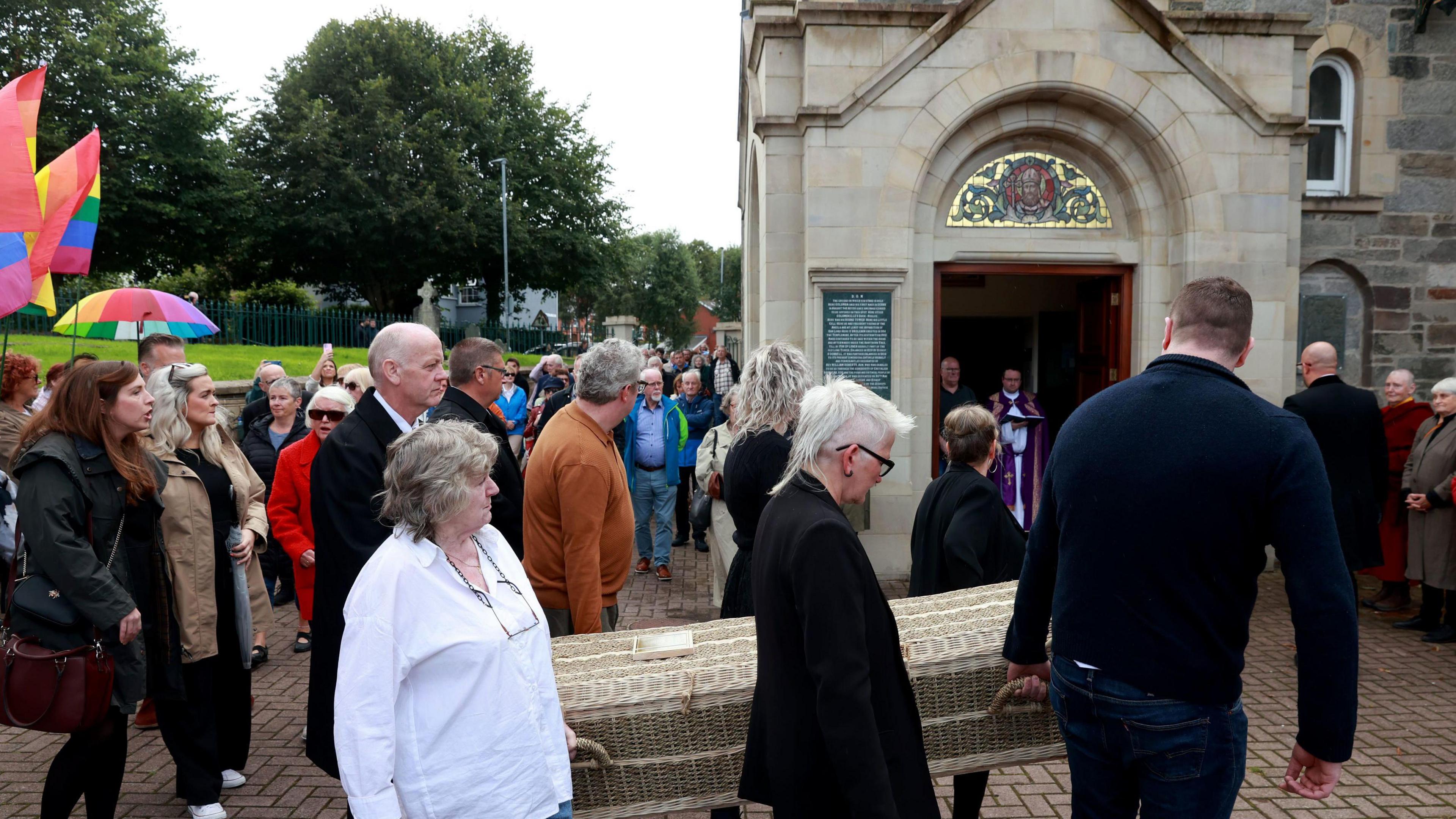 The coffin carrying Nell McCafferty is carried into St. Columba's Church, Longtower, Derry, for the funeral of the journalist and feminist activist