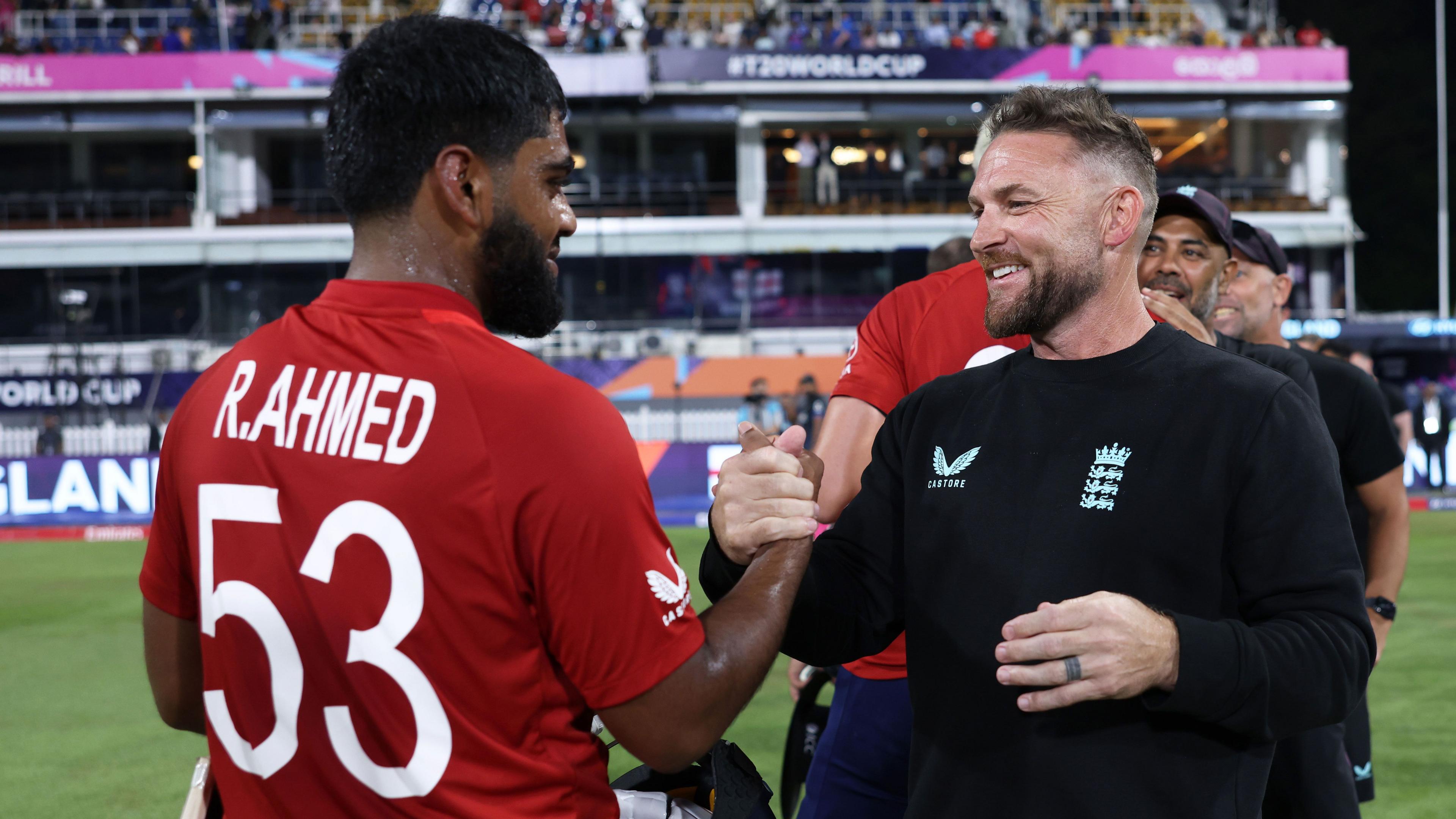 Rehan Ahmed and Brendon McCullum cup hands after England beat New Zealand at the T20 World Cup