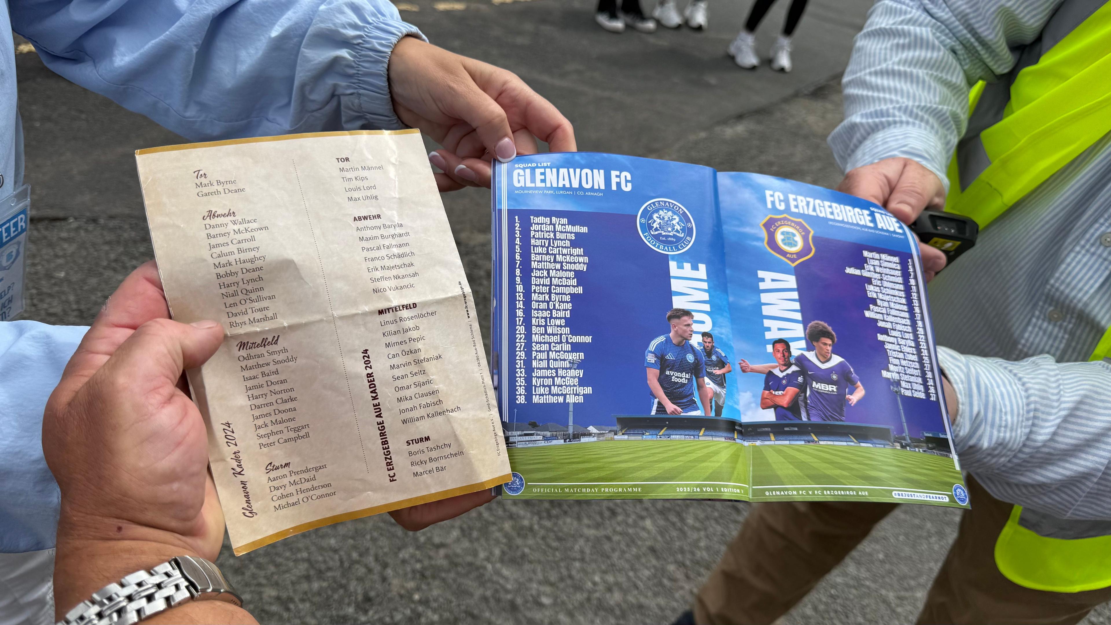 Two football match programmes, one from the original tie in 1959 on a single sheet of paper, the other from the 2025 tie in the form of a glossy book. 
