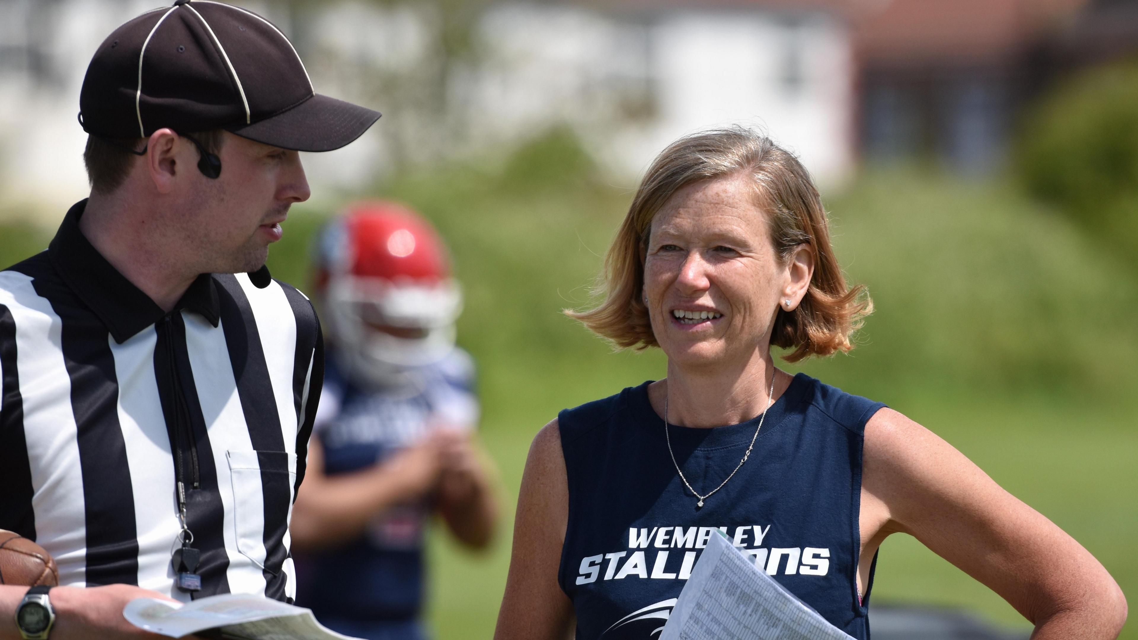 Jackie Smart [right] talks to a referee at a Wembley Stallions match