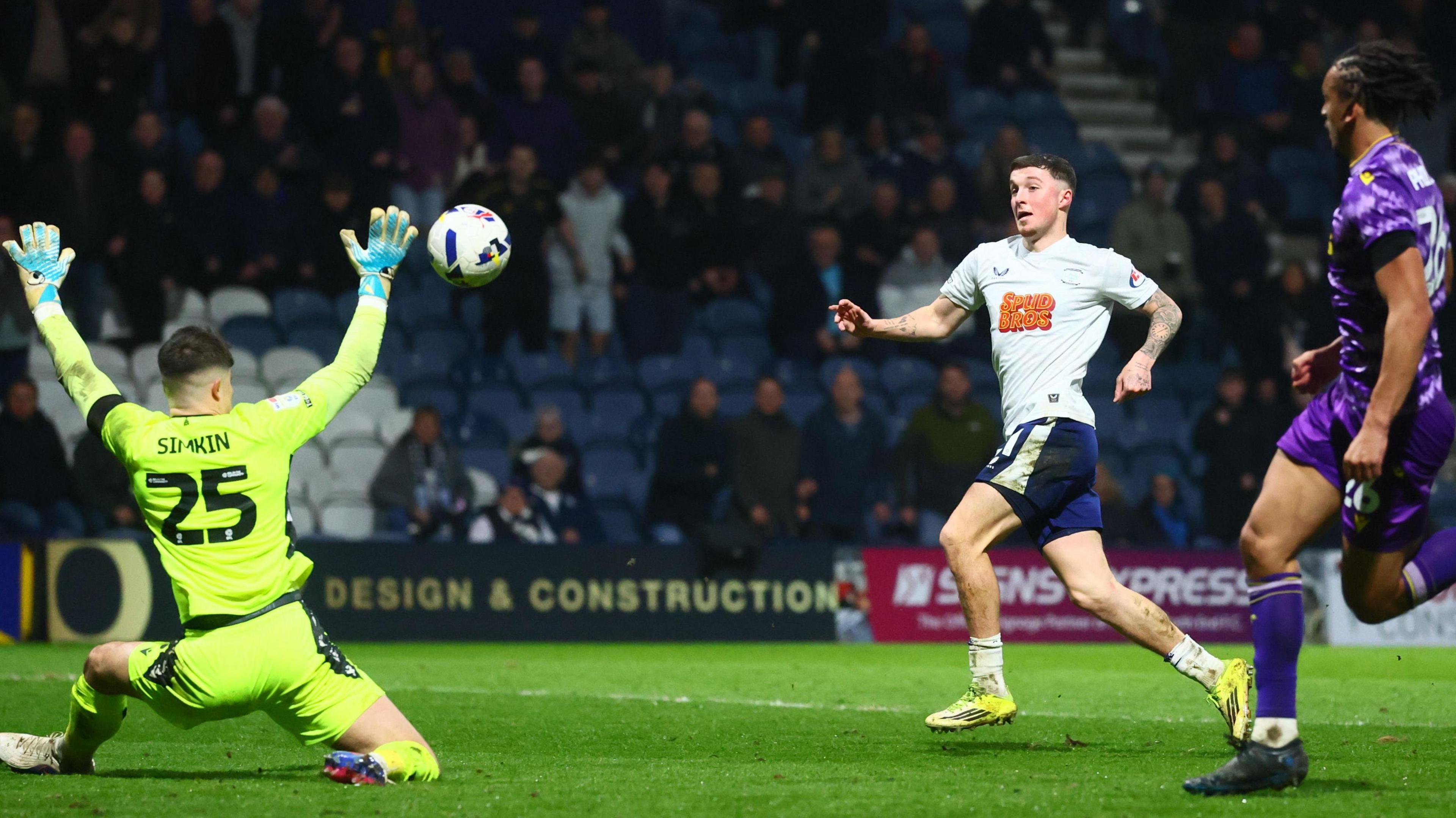 Alfie Devine chips Stoke goalkeeper Tommy Simkin to score his second goal for Preston.