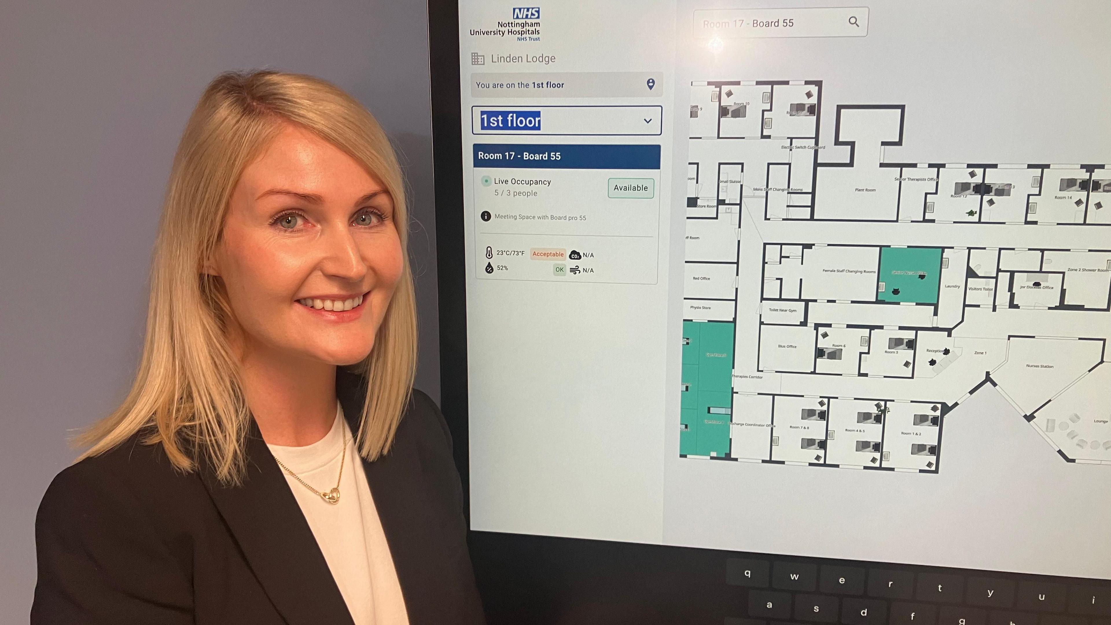 Linden Lodge Ward Manager, Sarah Davies with a digital map of the unit to see bookable rooms and resources
